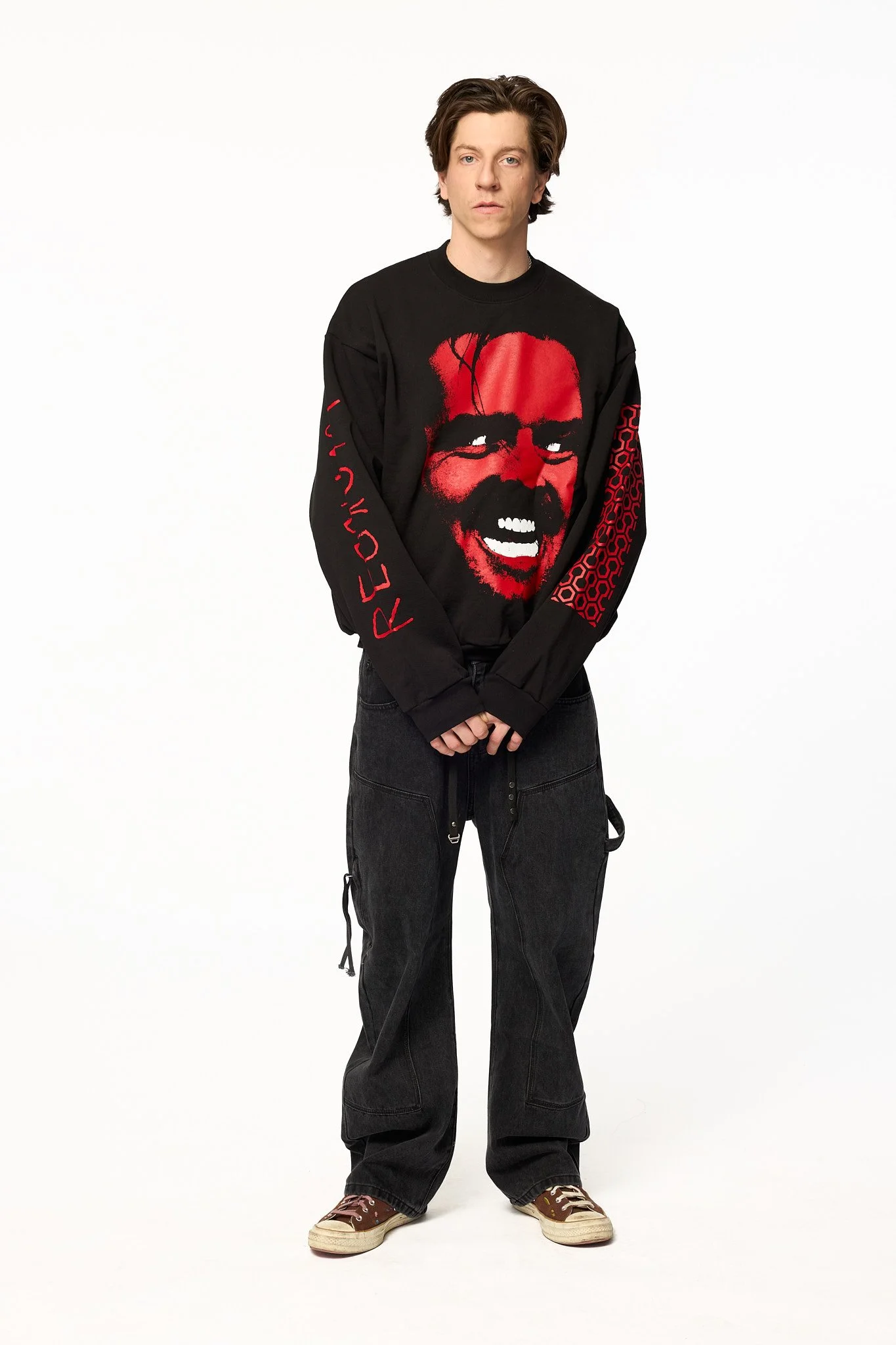 Black The Shining crewneck sweatshirt angled view showing oversized fit and sleeve graphics