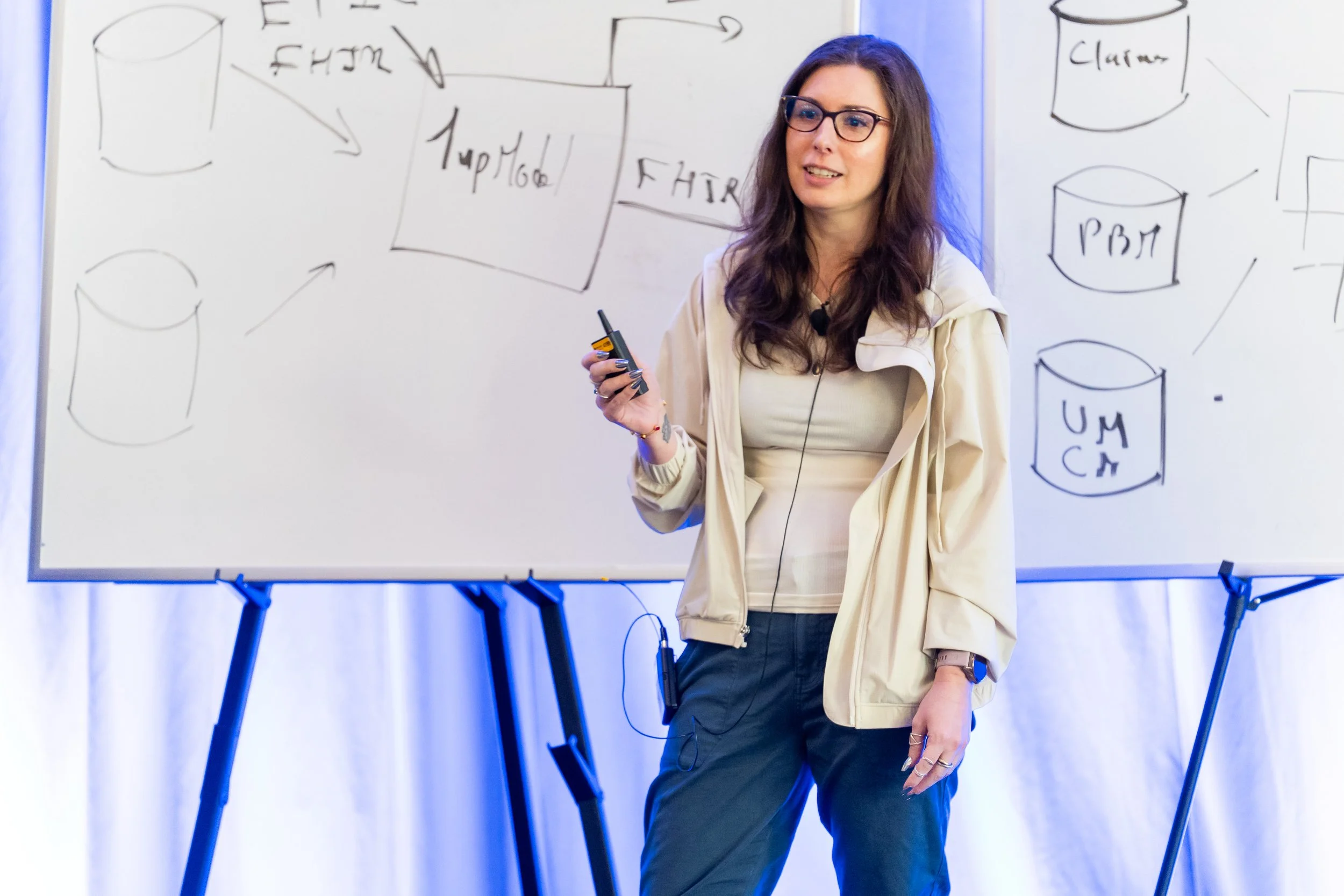 Katie standing on a stage giving a talk