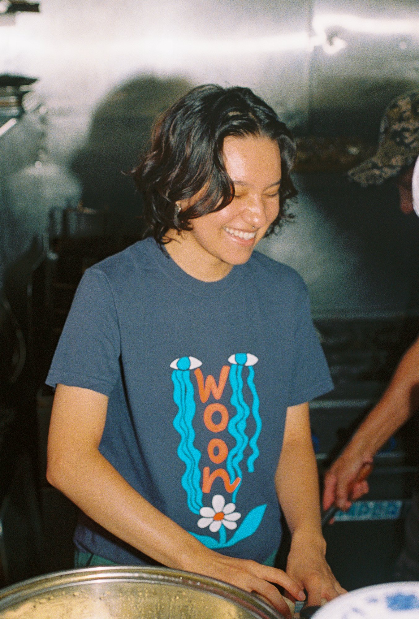 A person wearing a faded navy t shirt
