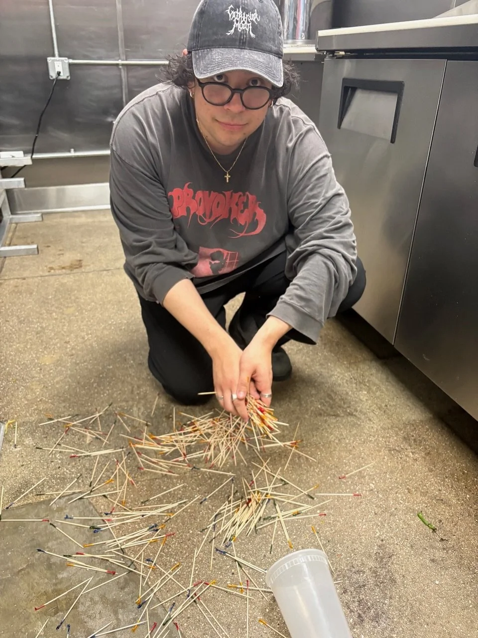 person picking up toothpicks