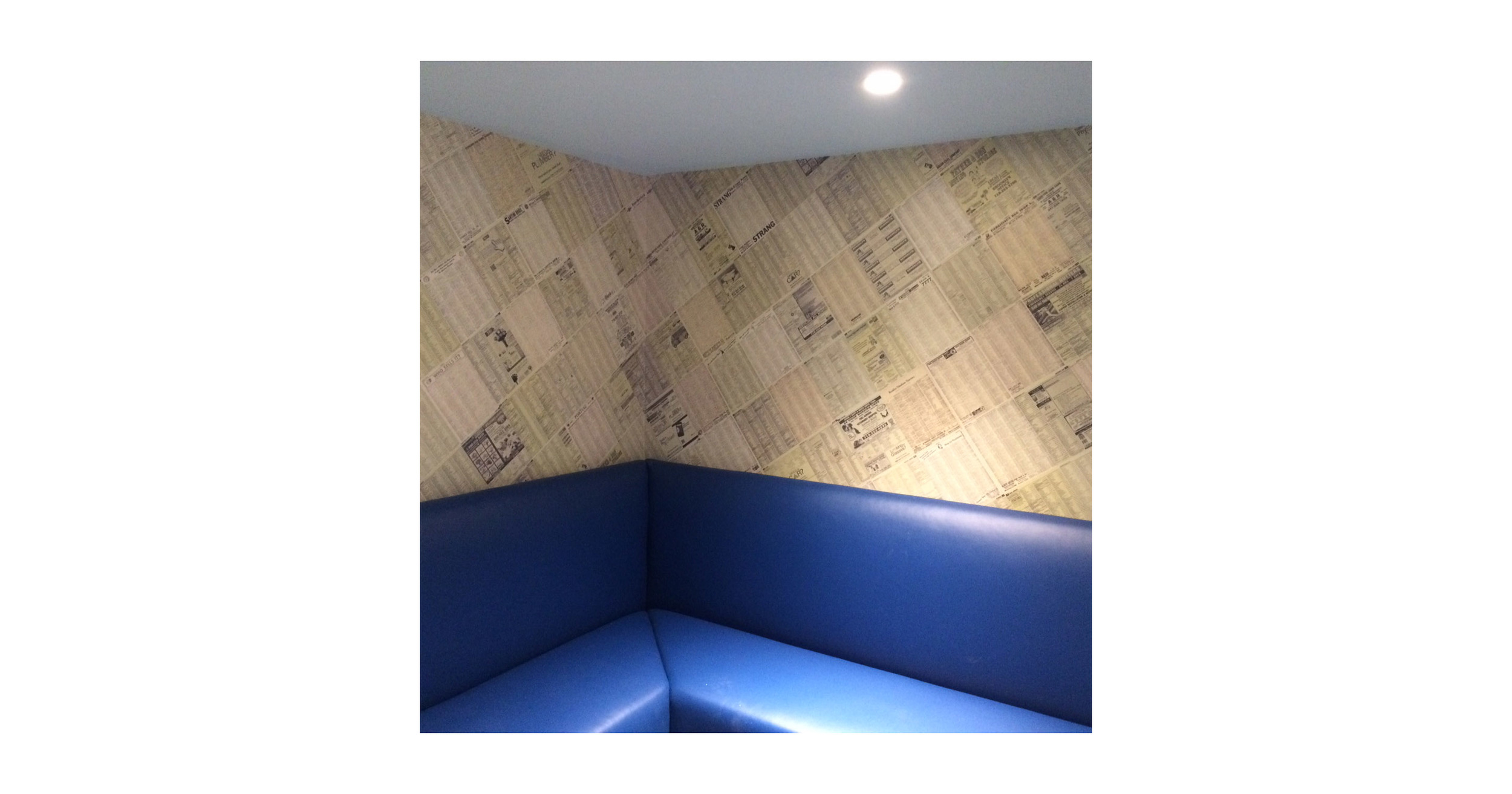 Custom wallcovering made of Brooklyn Yellow pages spanning from 1908-2015.