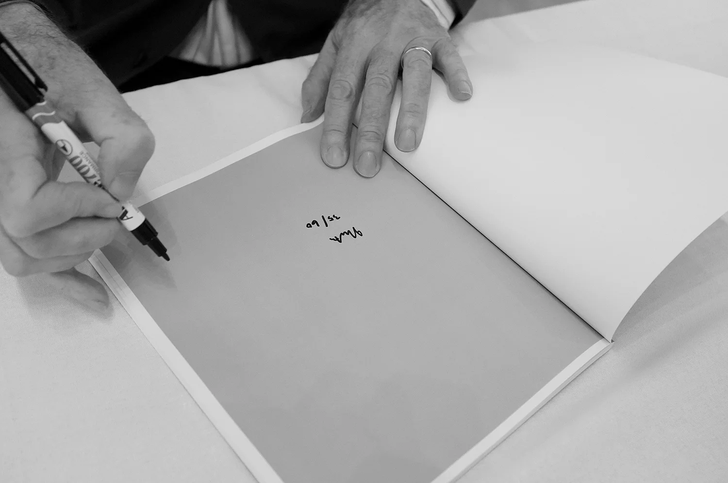 Ian North signing and numbering Felicia: South Australia 1974-1978 on the occasion of its public launch at Australian Centre for Photography, Sydney, 20 April 2013. Photo: Pedro de Almeida.