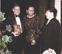 Glen Mayer, UPS, and Susan Bari, WBENC, congratulate Applause Award winner Carol Martin, Sears, Roebuck and Co.