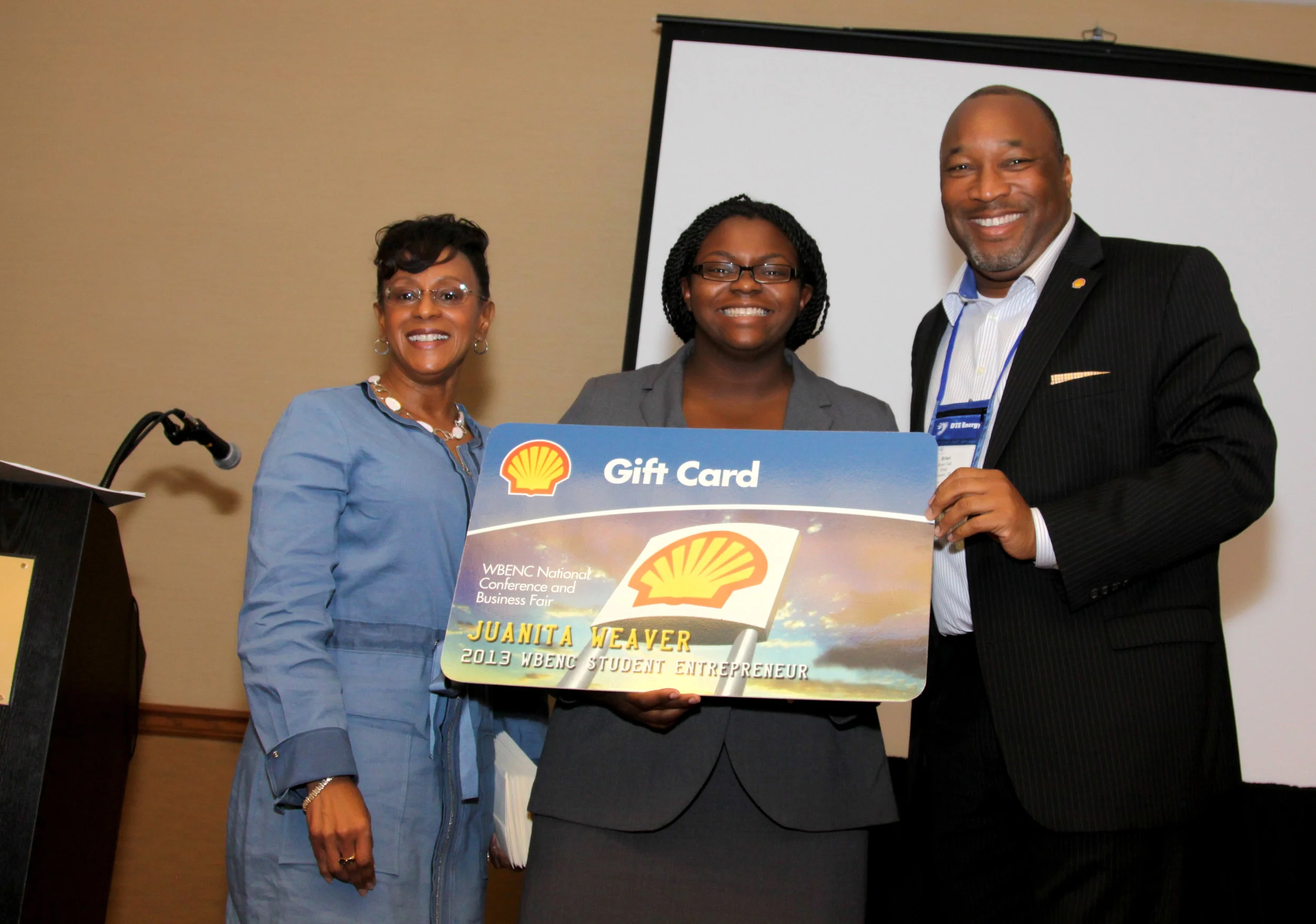 Juanita Weaver (center) with representatives from Shell.