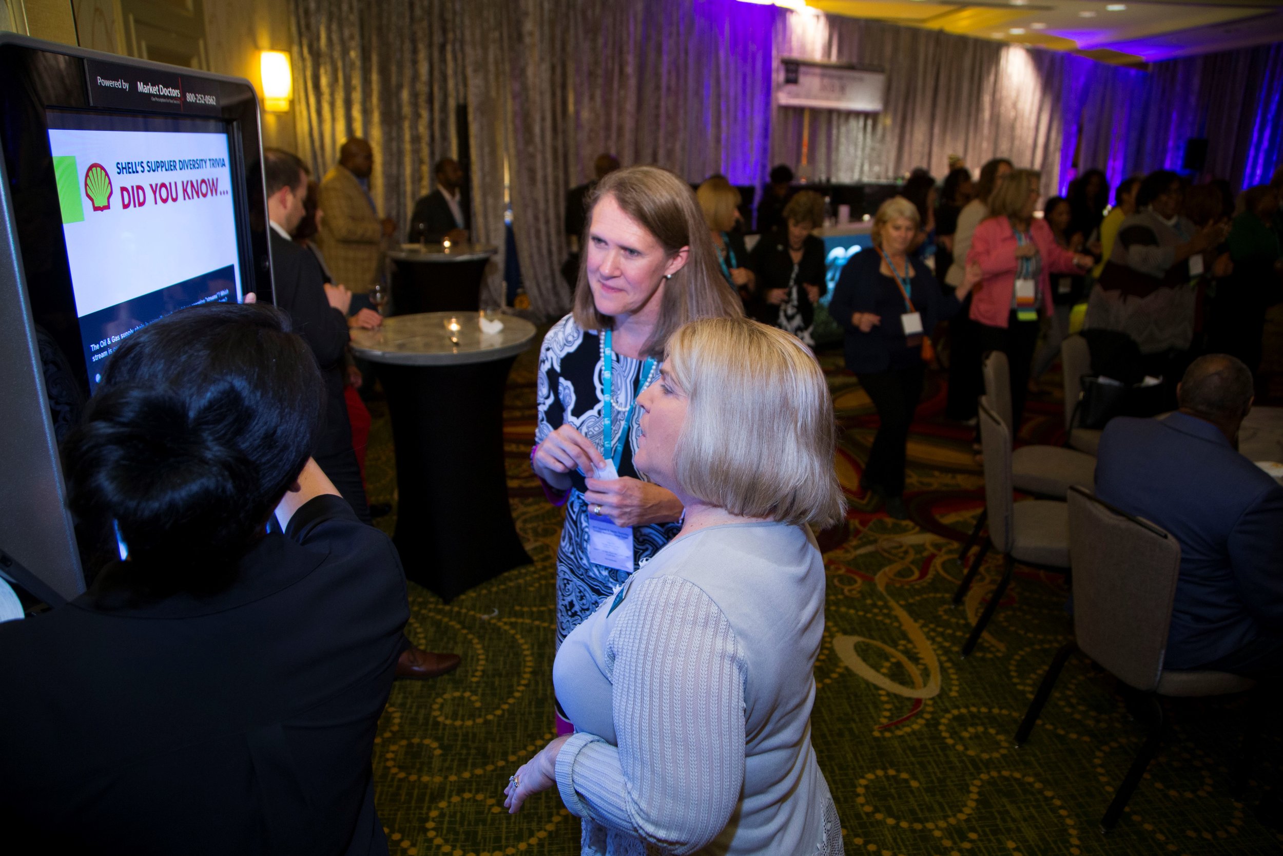 Shell General Manager for Global Trading & Supply, Genny Winter and WBENC President Pamela Prince-Eason take a close look at the educational interactive kiosk at the Shell Sponsored Summit & Salute Welcome Reception.