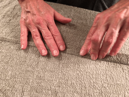 Applying pressure on the seams with your fingers helps keep the seam in place while creating a flat felled seam.