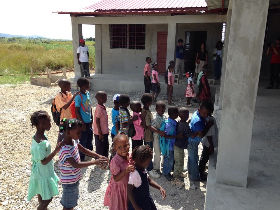 The students line up to go back into class at their new school.