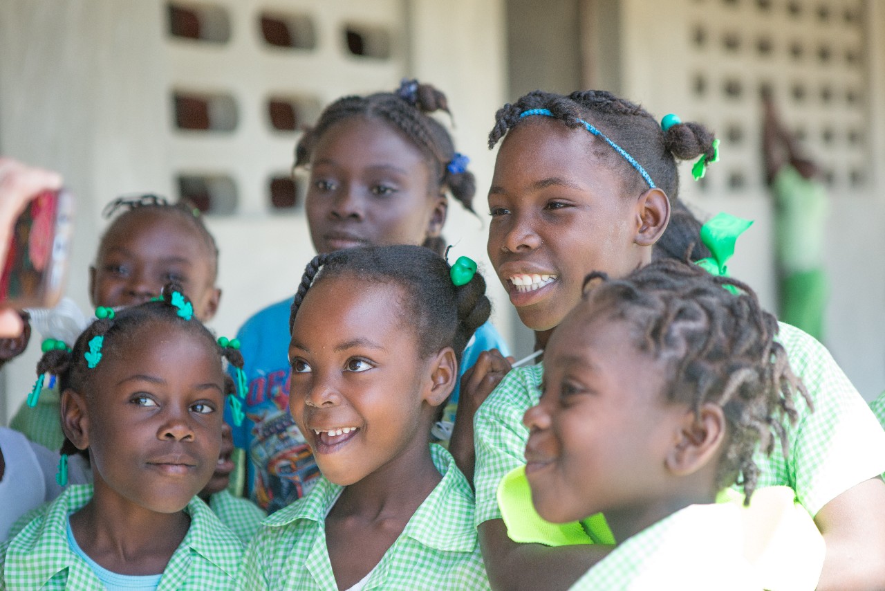 These children proudly wear their school uniforms sewn by village women on donated sewing machines. 