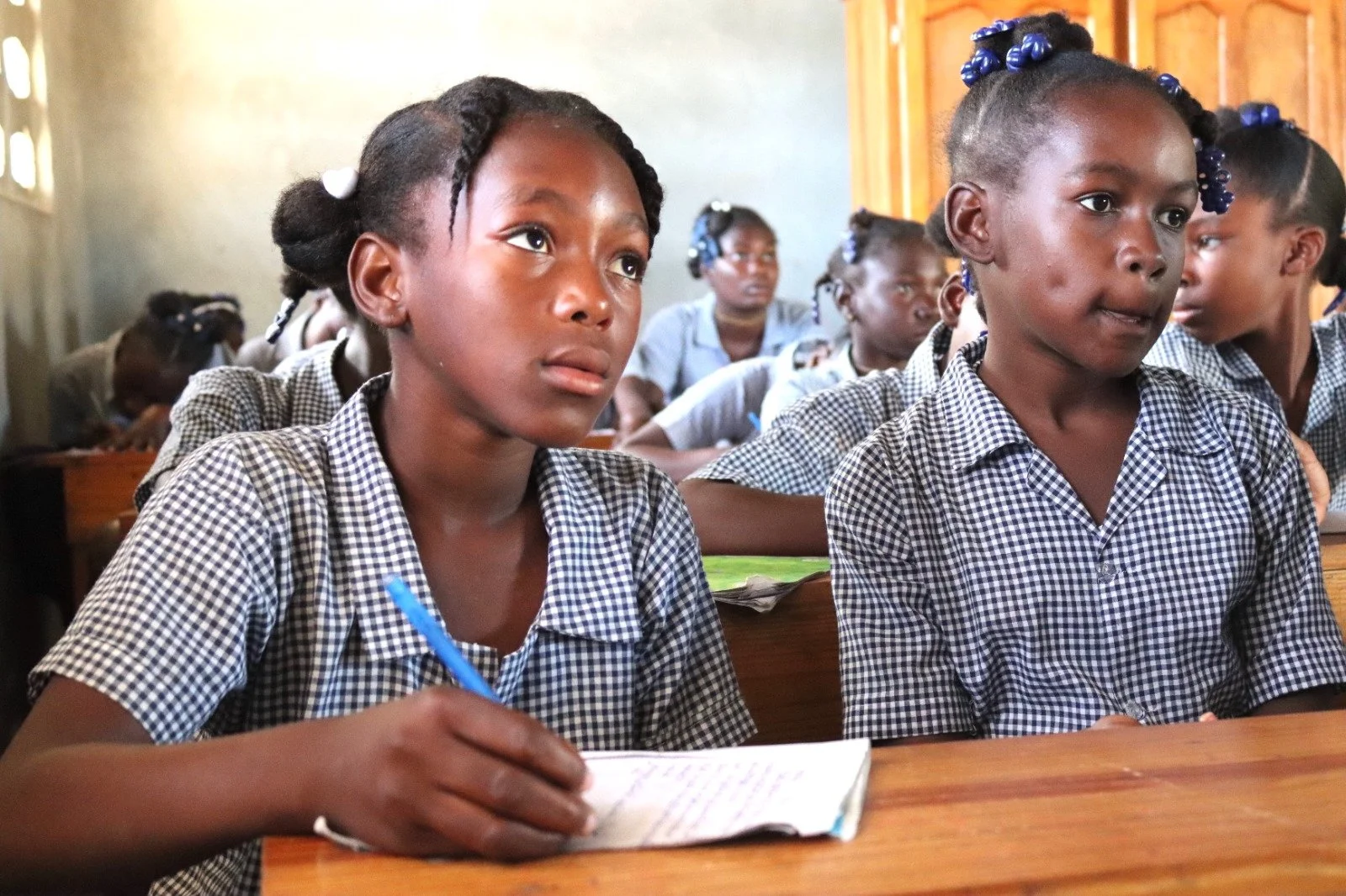 "Students at Haiti EcoVillage School engage in learning, embodying the vision of education as a tool for justice and community transformation."