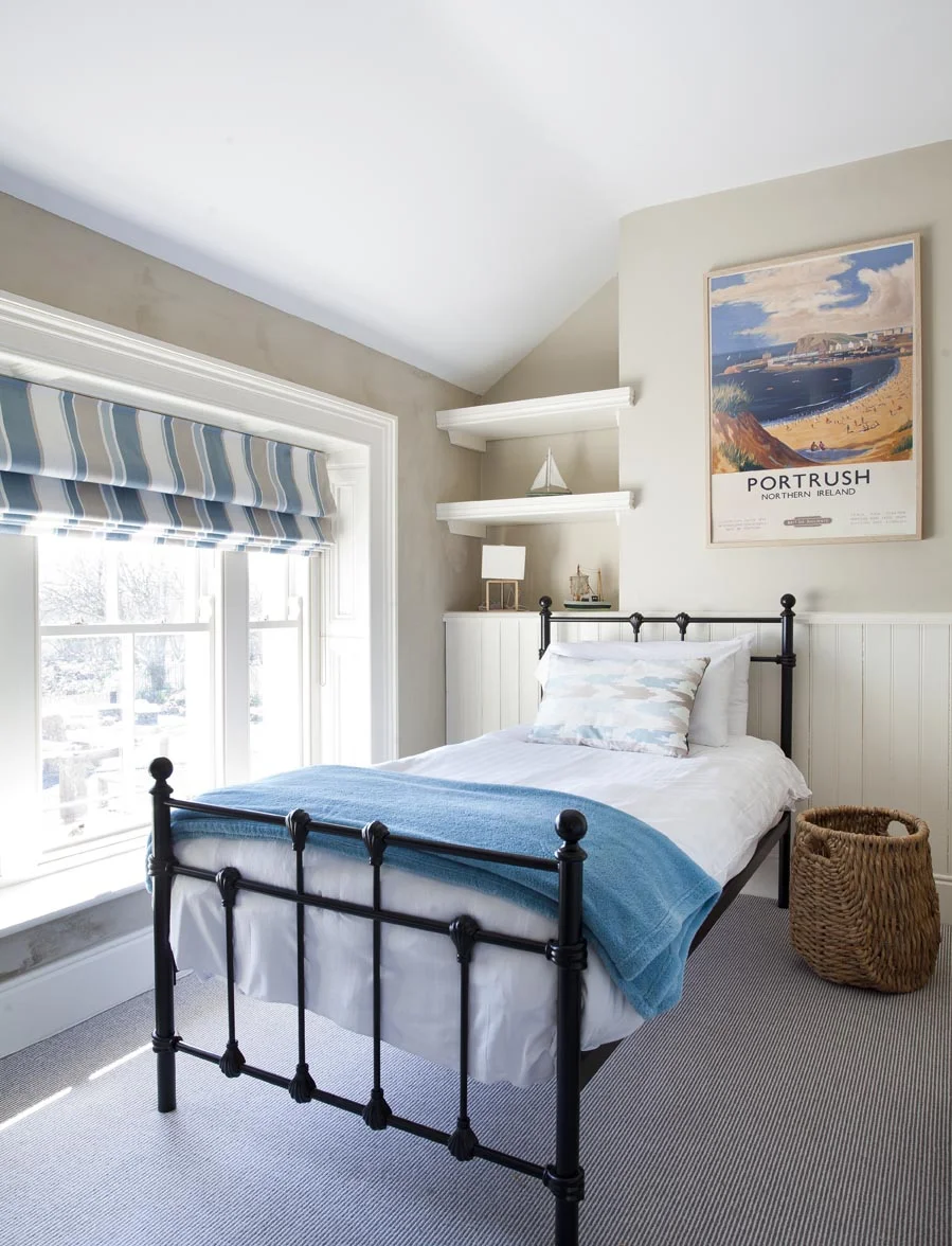 Each of the five bedrooms has its own distinct character, dictated by a different vintage railway print. The colours throughout reflect the house's stunning sea views.
