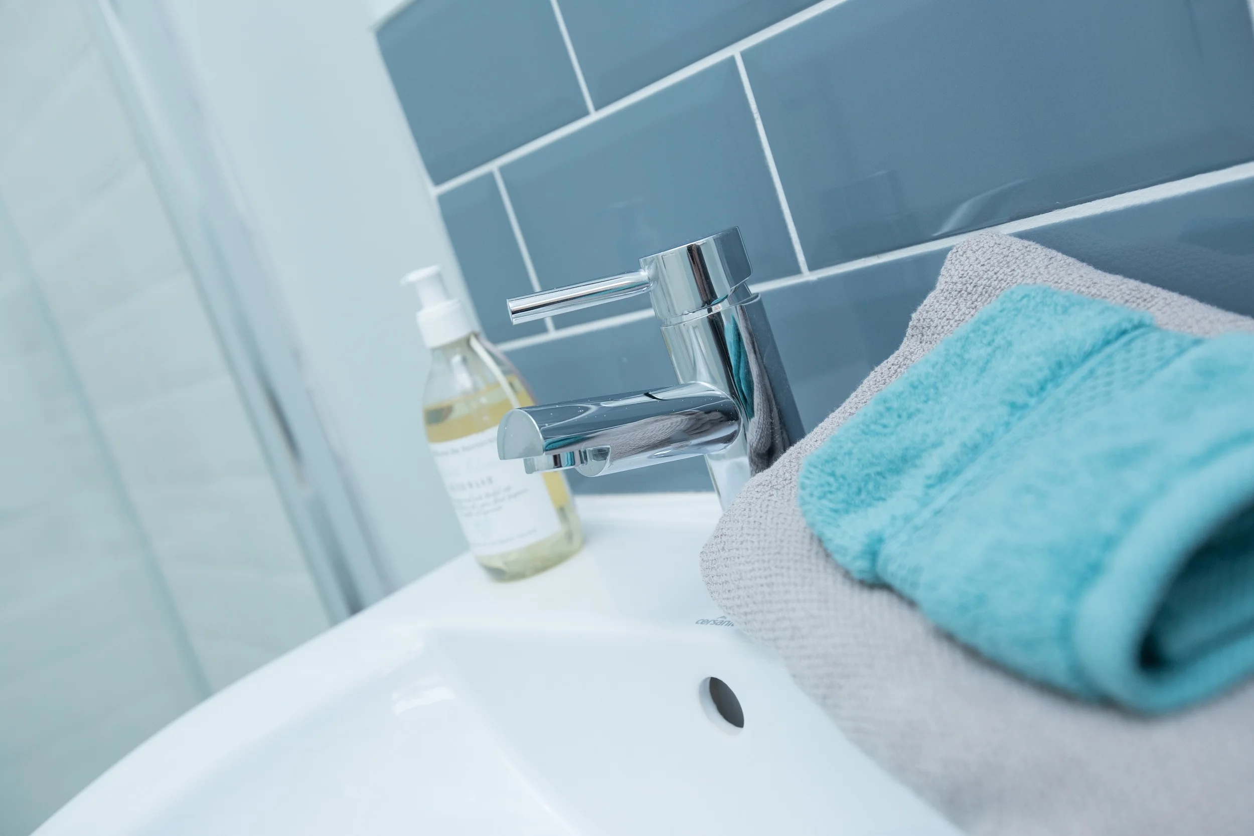Simple metro tiles in blue and white shades make for a timeless bathroom.