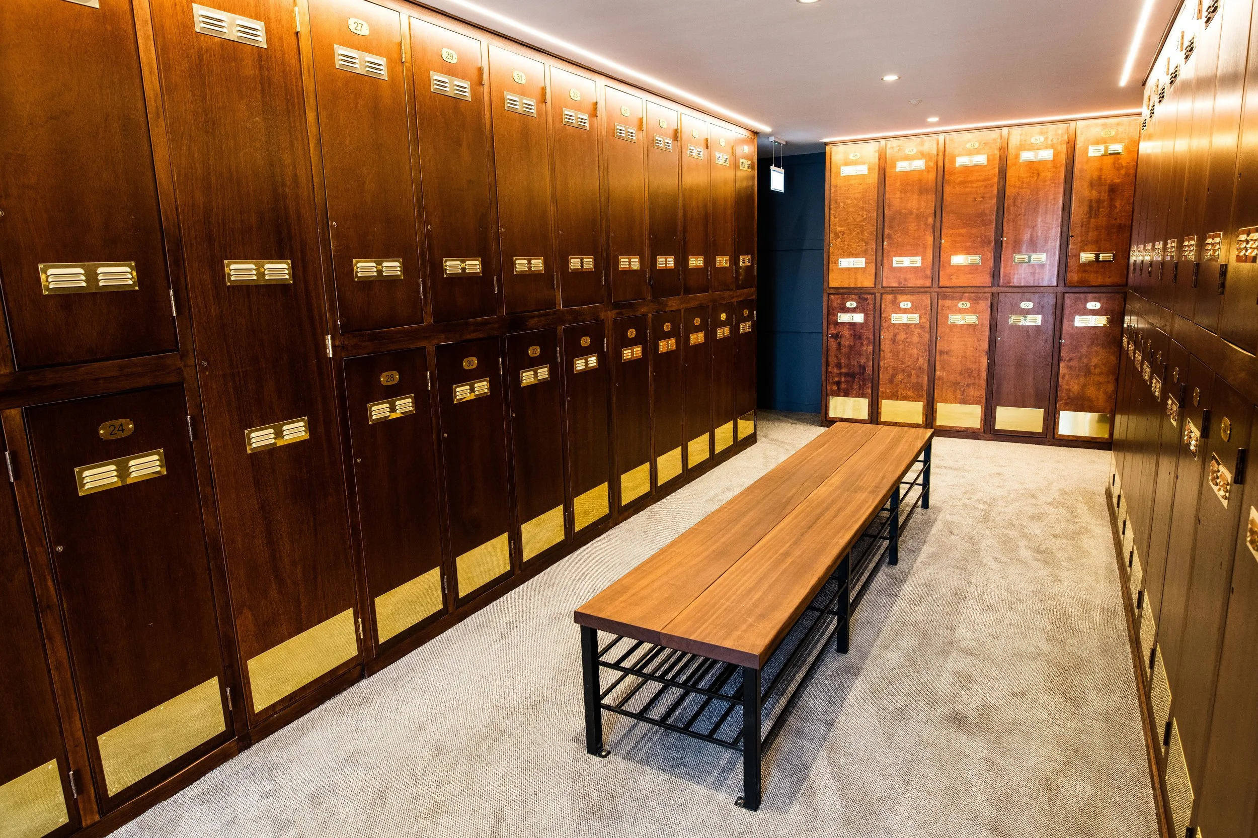 The banks of original lockers were completely refurbished and dressed with solid brass fittings. New benches were designed with solid mahogany tops and incorporate handy shoe racks underneath.