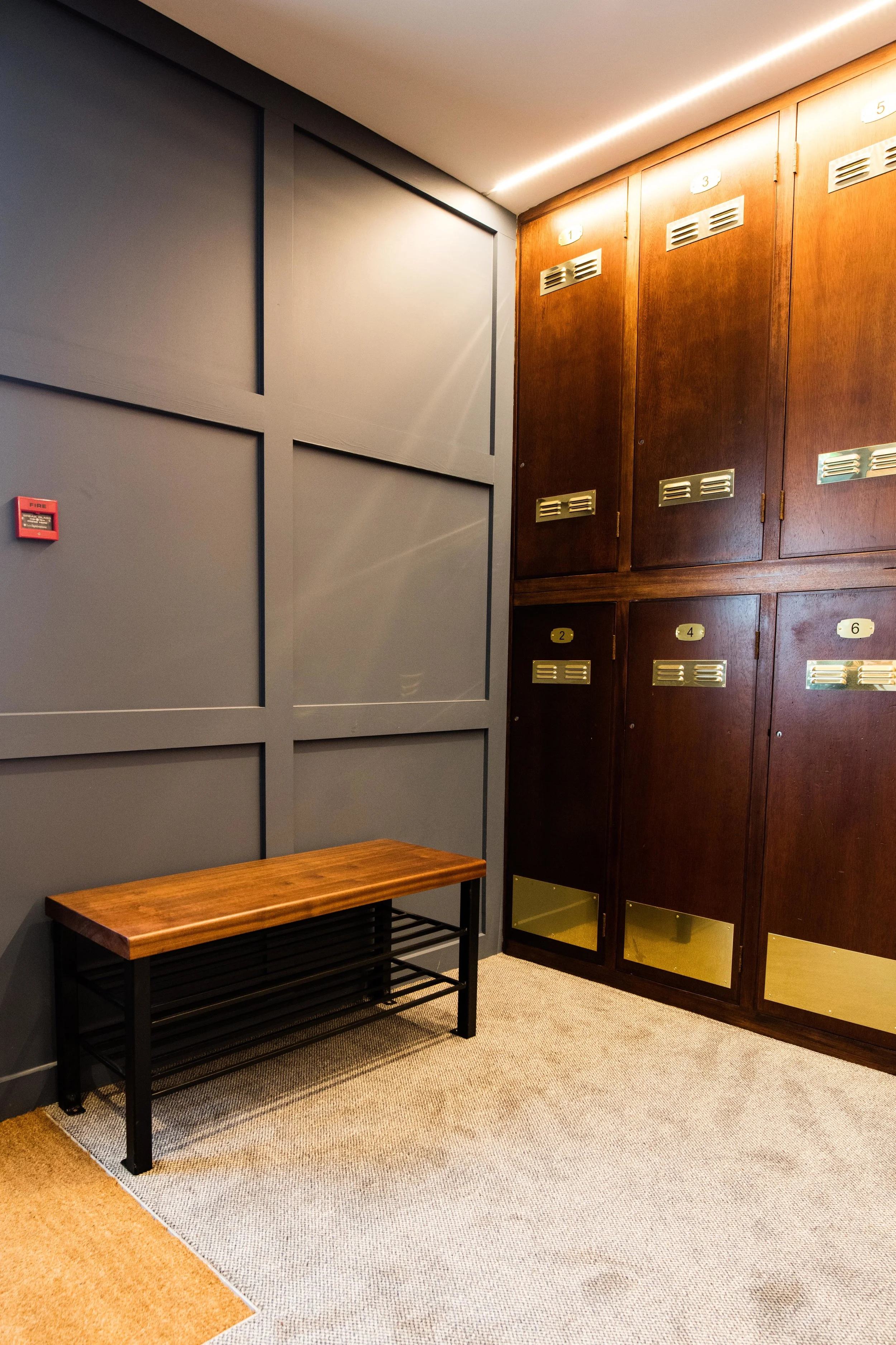 Simple wood panelling was used to dress the walls - painting it a storm blue shade helped to tone down the rich redness of the mahogany. This shade was further accentuated in the carpet.