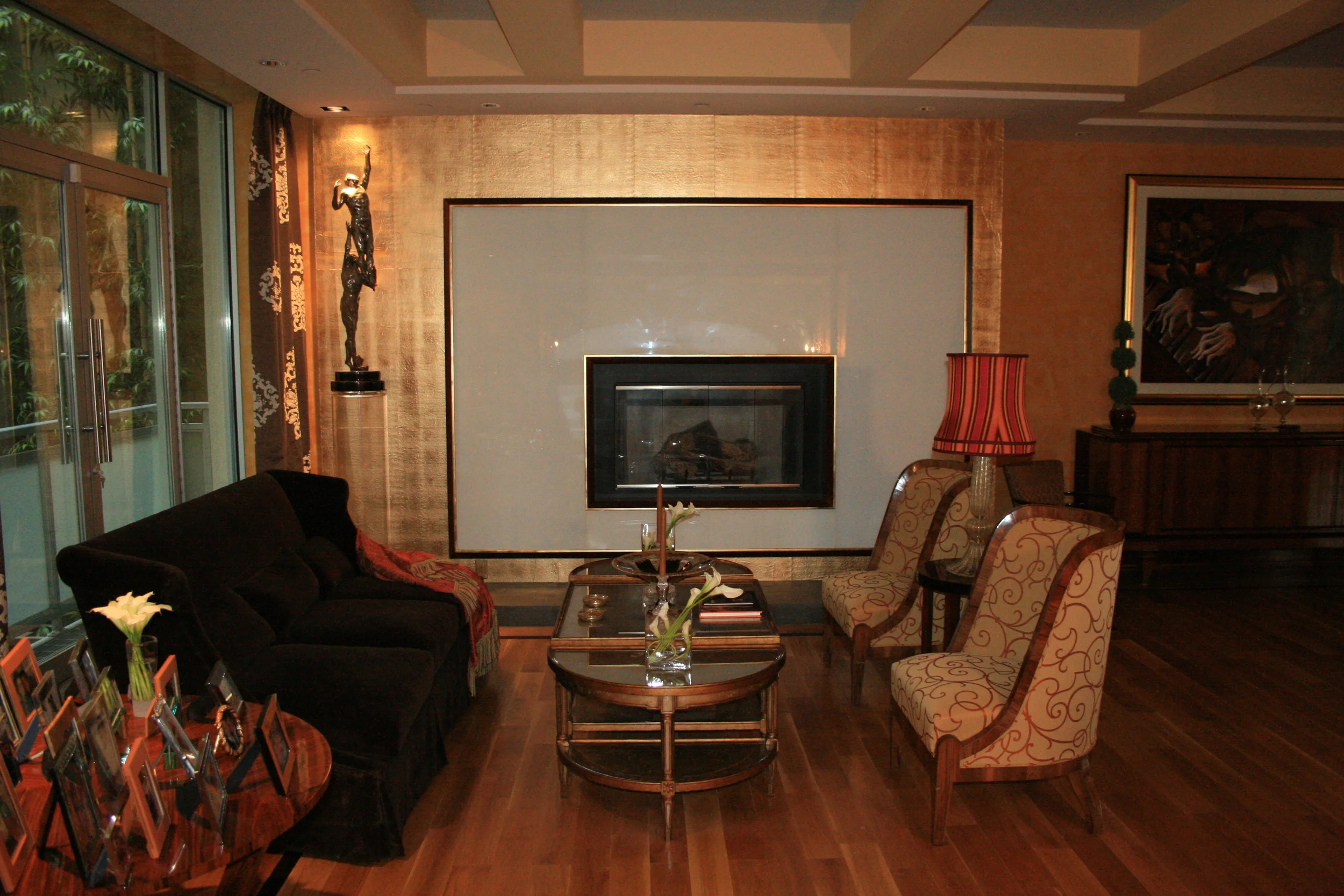 Gilded gold leaf fireplace in living room of NYC apartment.