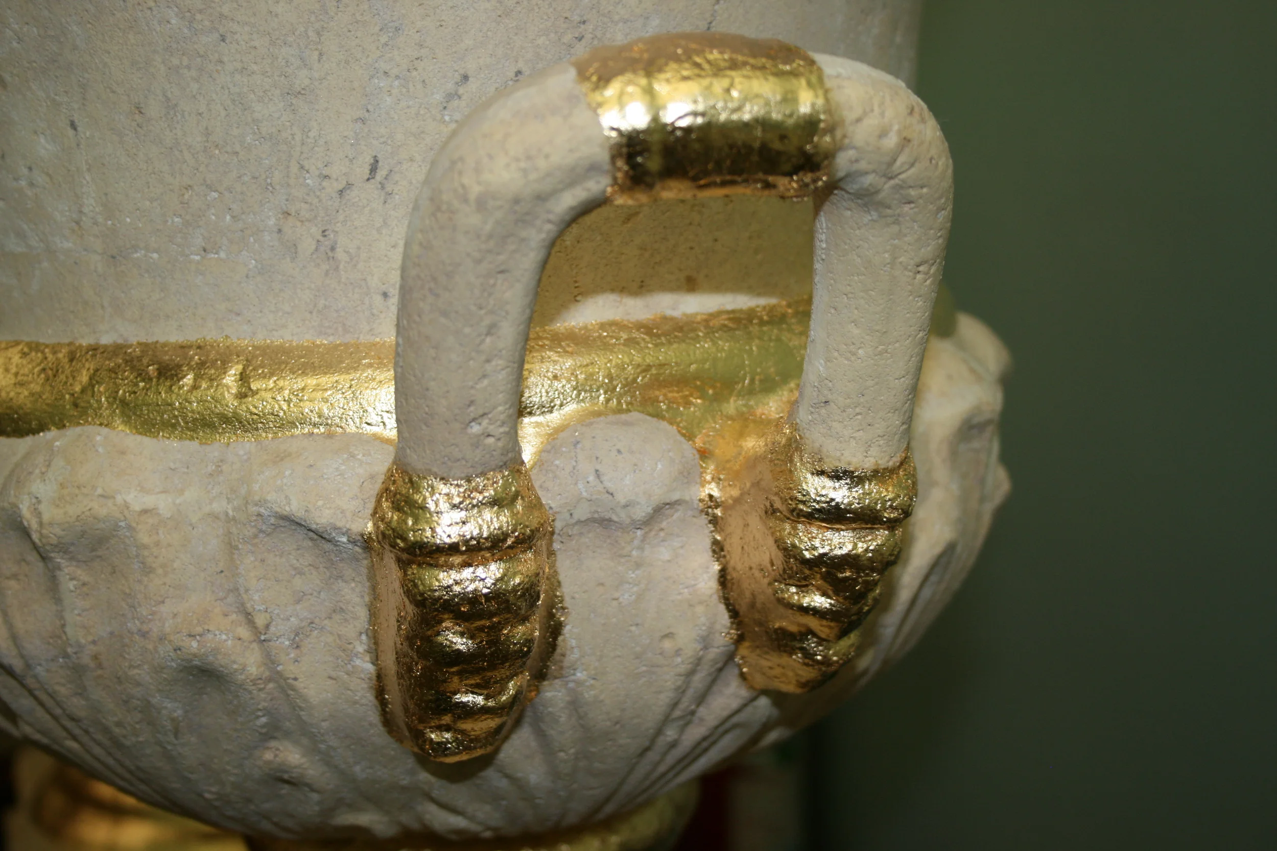 Gold leaf gilding details for decorative urns