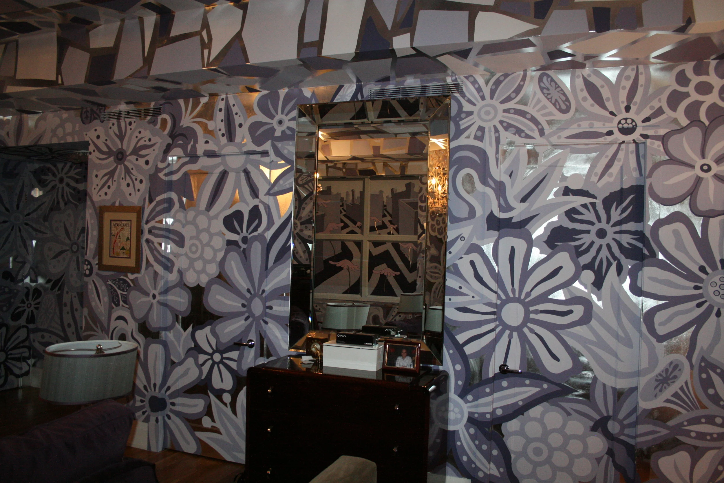 Hand-painted flower mural over gilded silver leaf walls