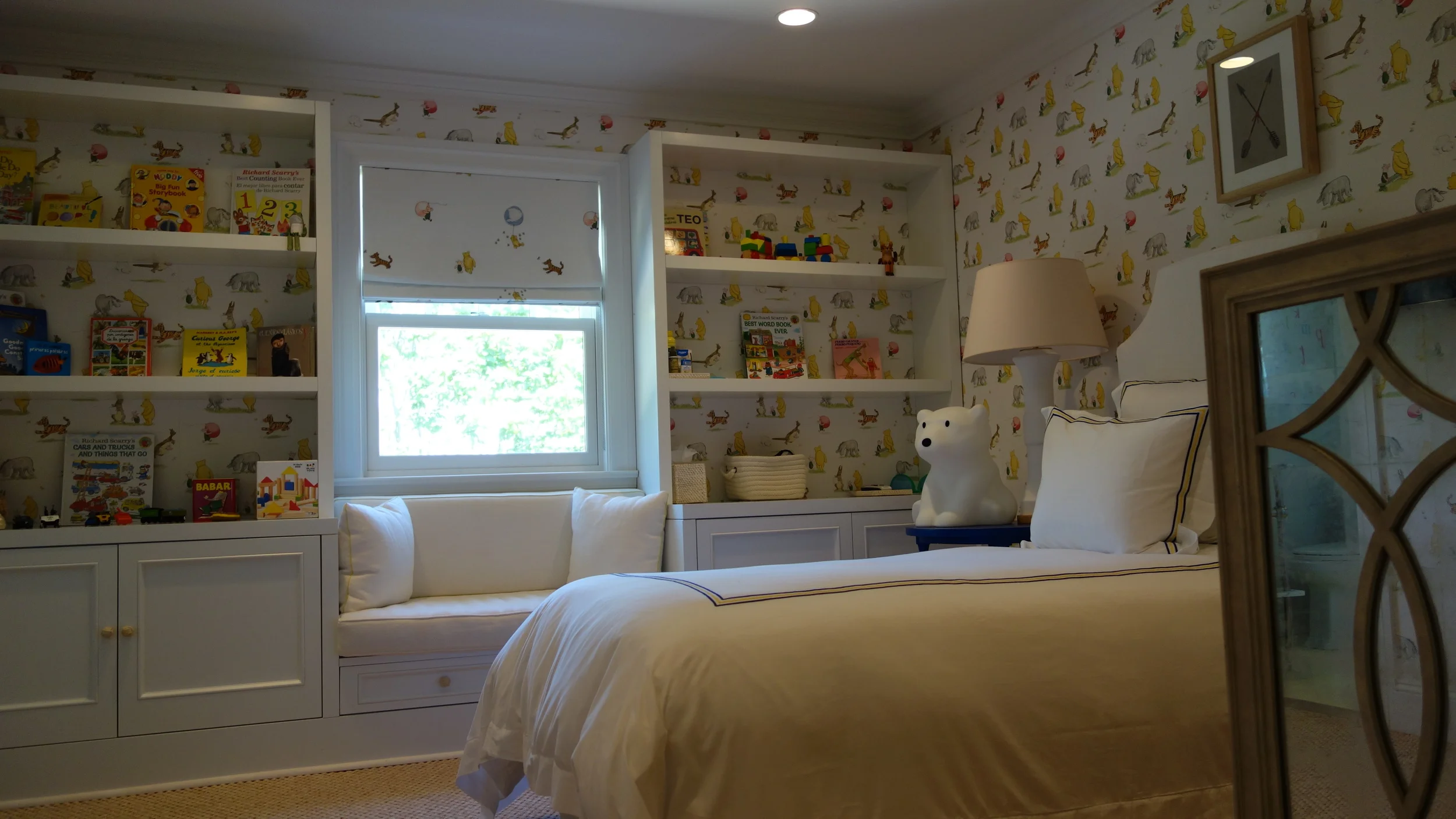 Custom shelving and banquette nook for nursery room