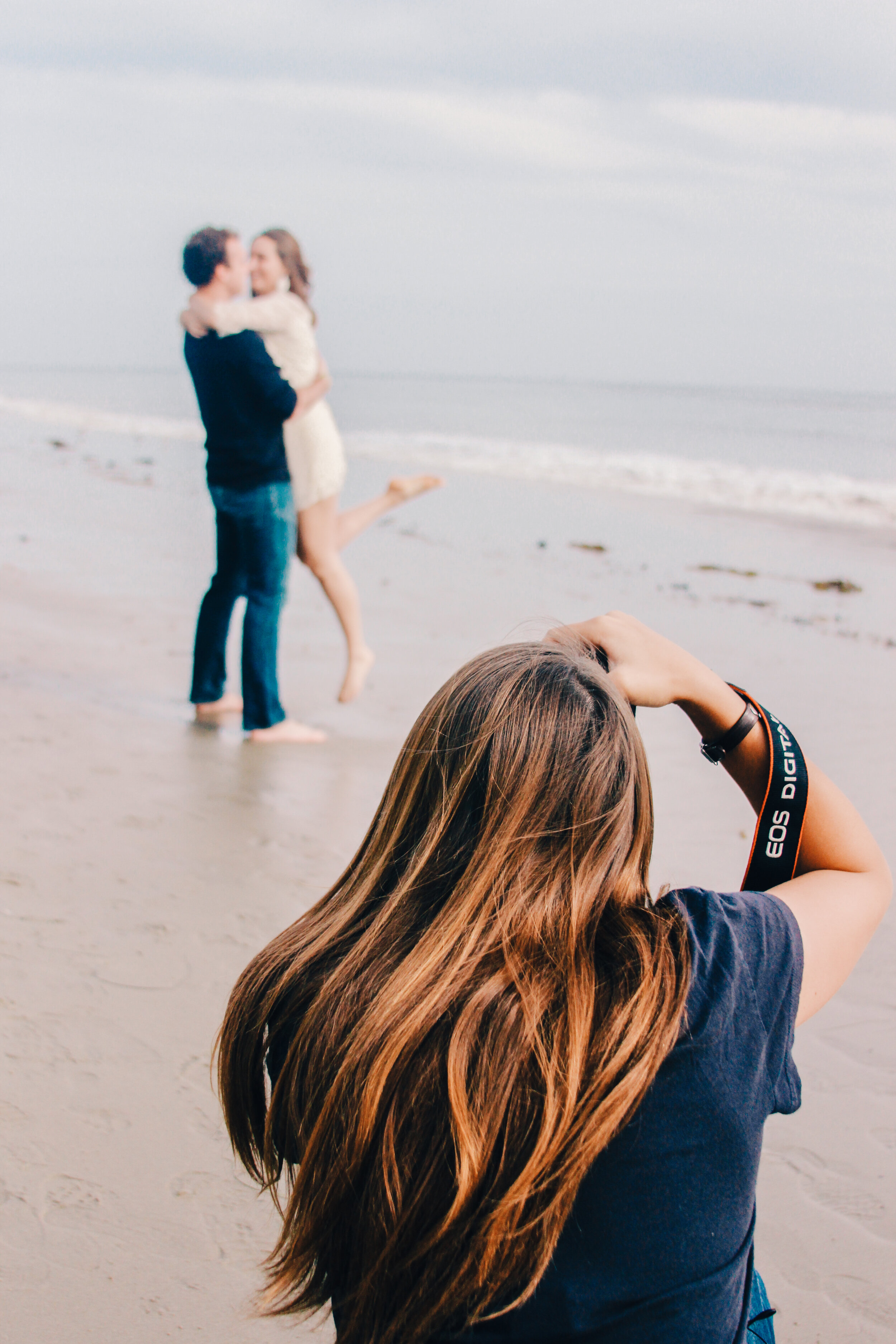 behind the scene engagement session on the beach