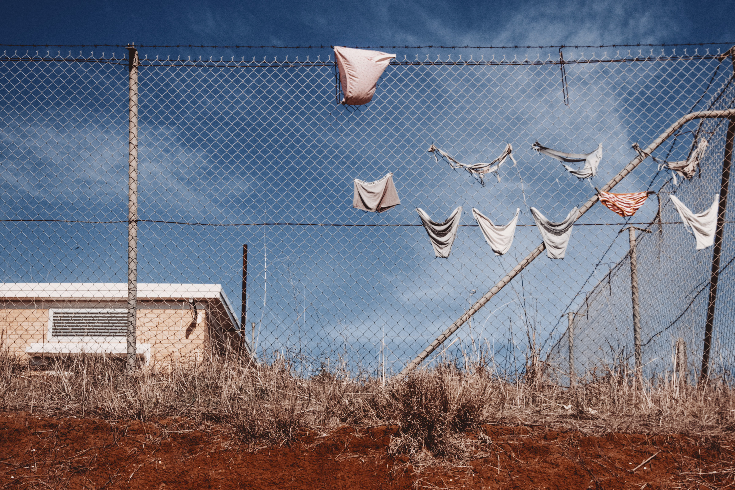 ‘Enjoy your stay / Australia’ is an ongoing photographic documentation that explores the subtle fragments of our current cultural and environmental thread. Finding herself drawn to the quiet thread of loneliness and desolation she sees sewn through nature and the city, these are images of suburban streets, adopted tradition, forgotten objects, unsuspecting subjects and beautiful, harsh landscapes. Never intended to be sentimental or saccharine, rather, to ask the viewer to think about who we really are, rather than who we want to be. On display are the absurdities of suburban life, fascinating, tragic and humorous all at once, And the vast spaces between presented as empty, lonely expanses.