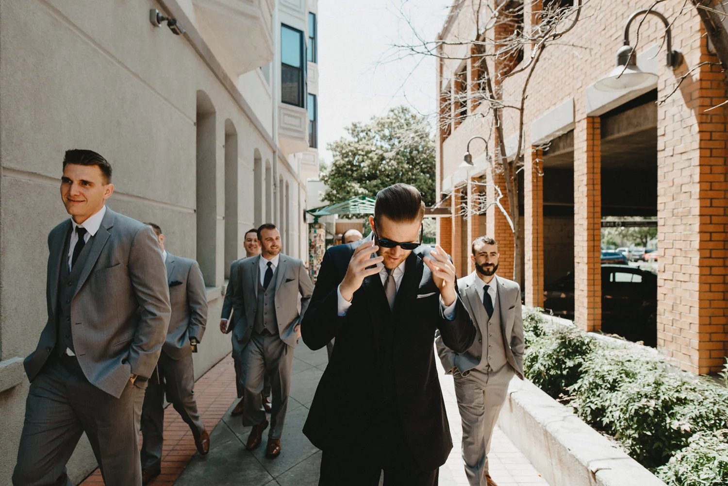 groomsmen walk together outside of hotel diamond in chico ca