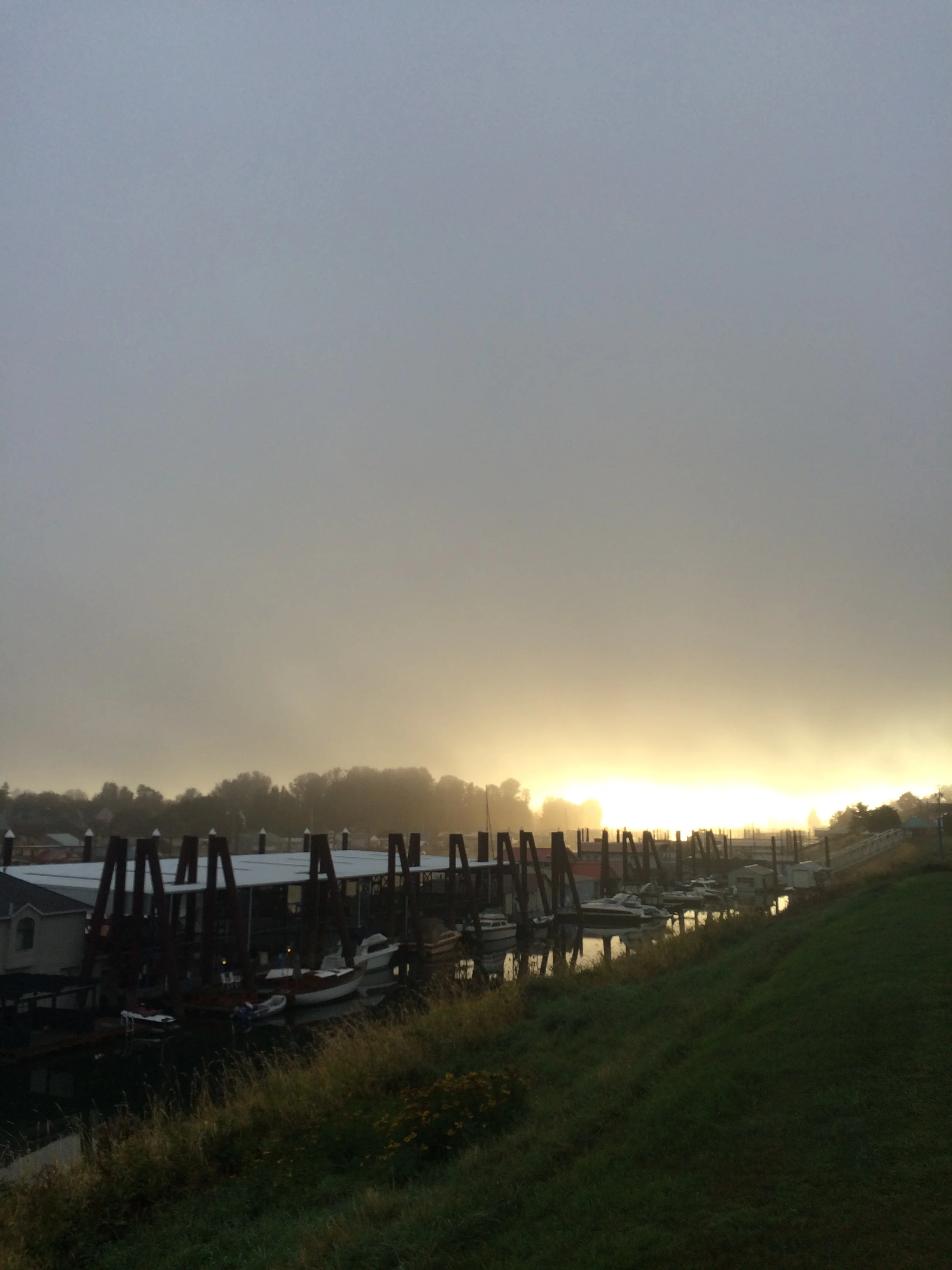 Fog clearing as the sun rises over the Columbia River in Portland.