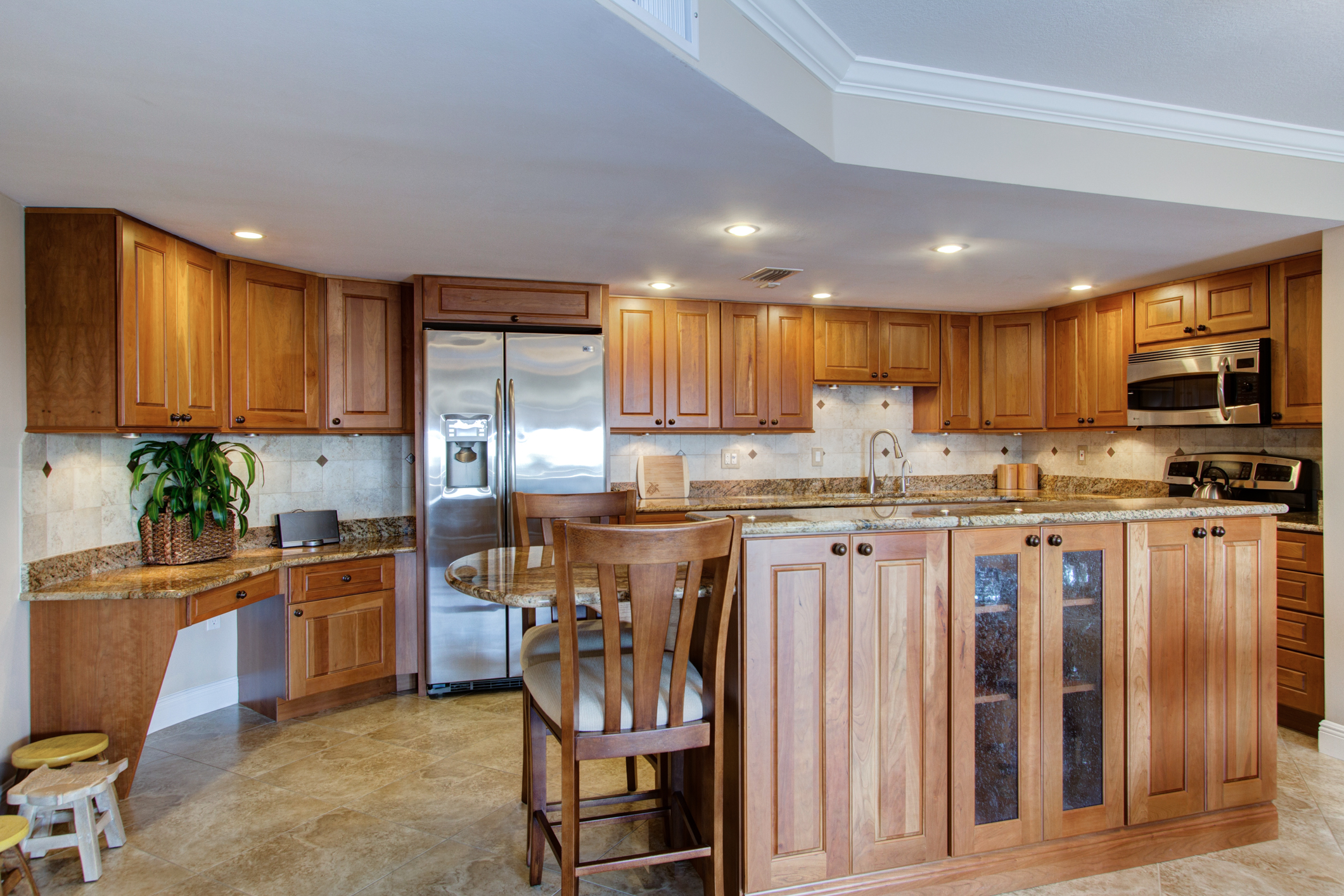 Island kitchen with stainless steel appliances and custom cabinetry