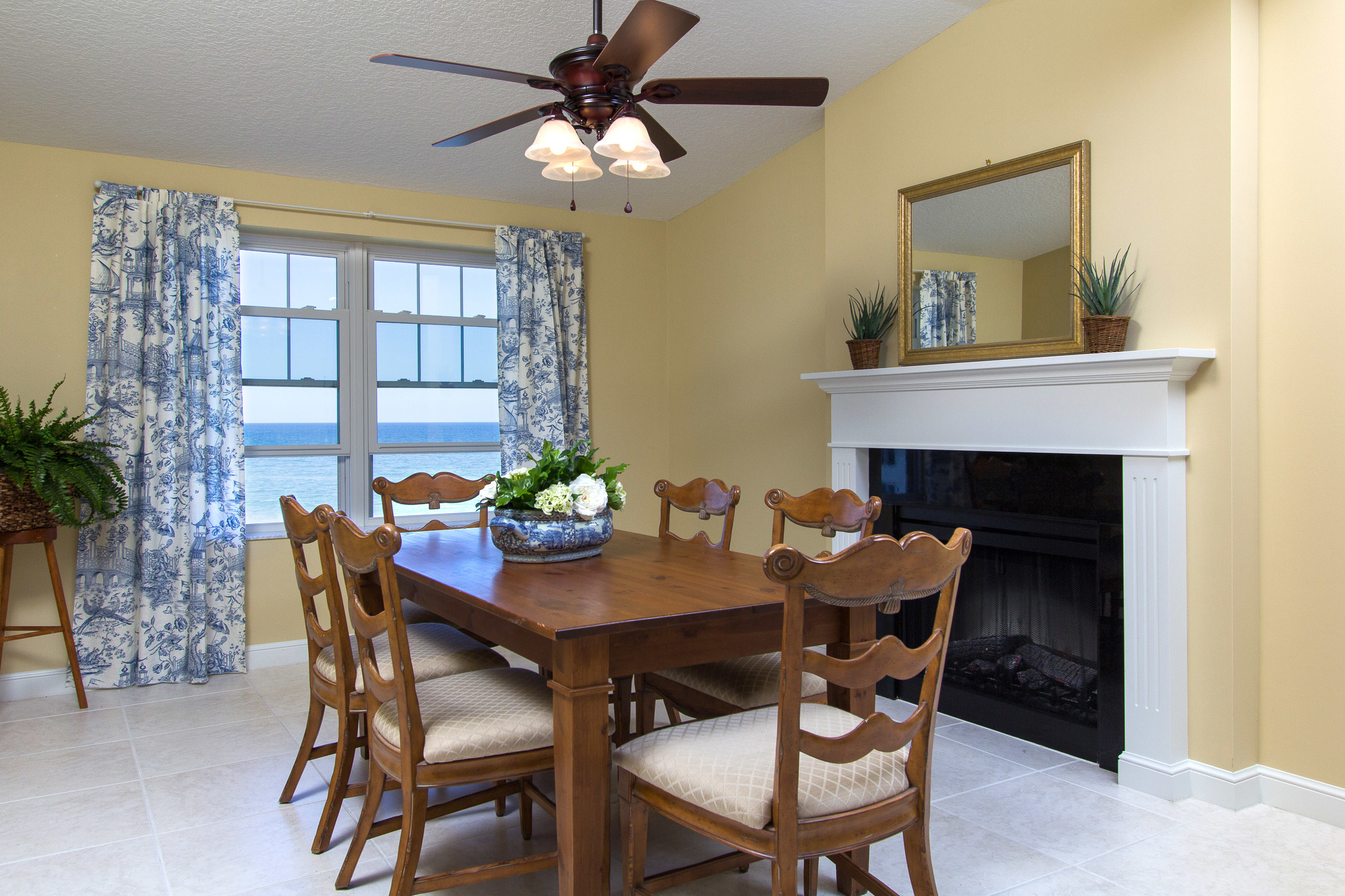 Dining area adjacent to a fireplace and ocean views