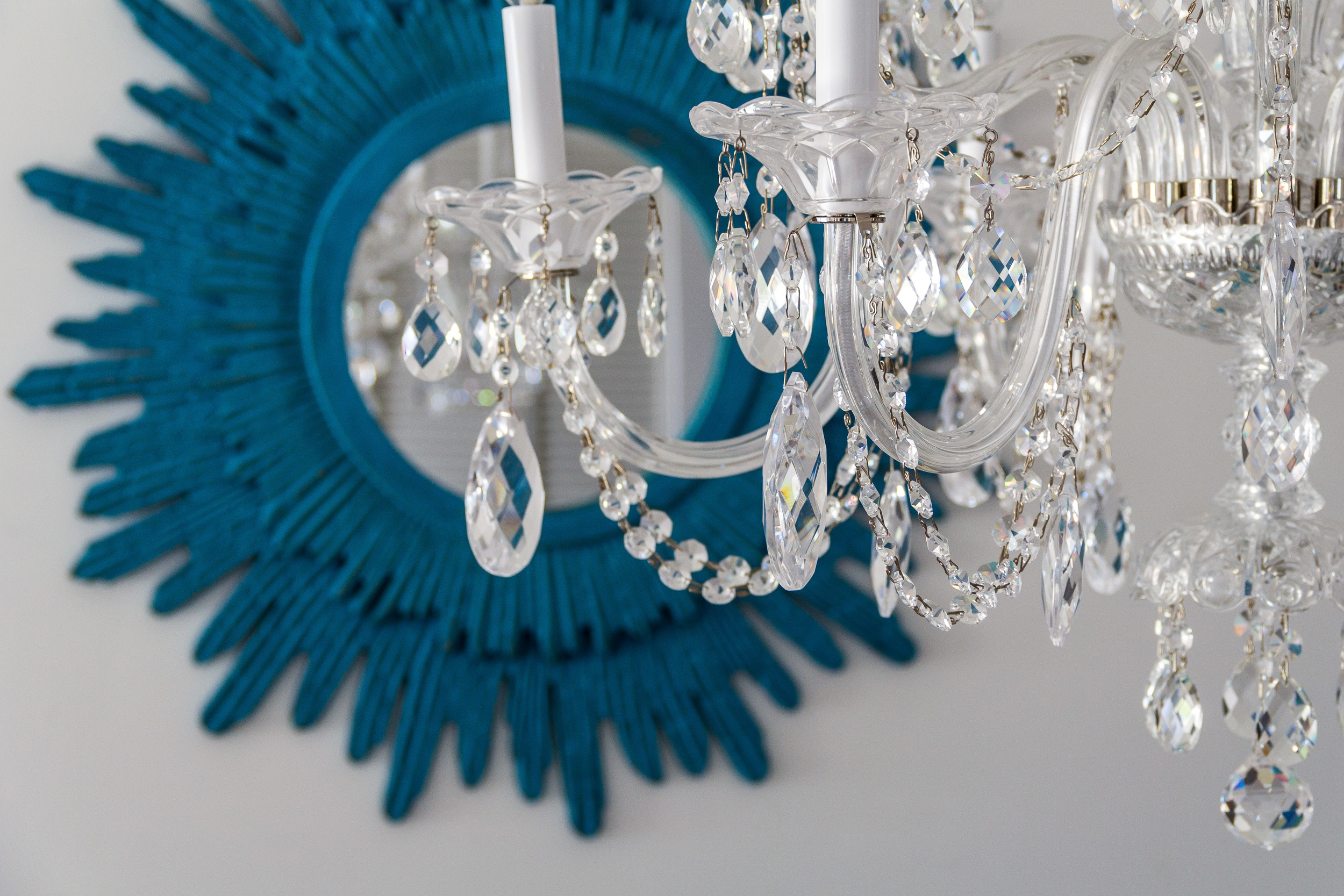 a decorative image of a chandelier and a mirror