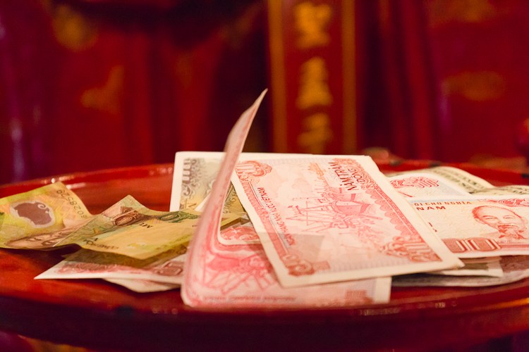 Money left at a shrine in the Temple of Literature in Vietnam.