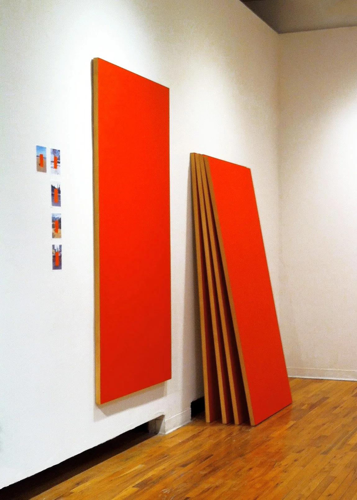 Red Door Tourist install, 2014, Five 7" x 5" photographs of painted red doors traveling throughout the five boroughs of New York in Summer