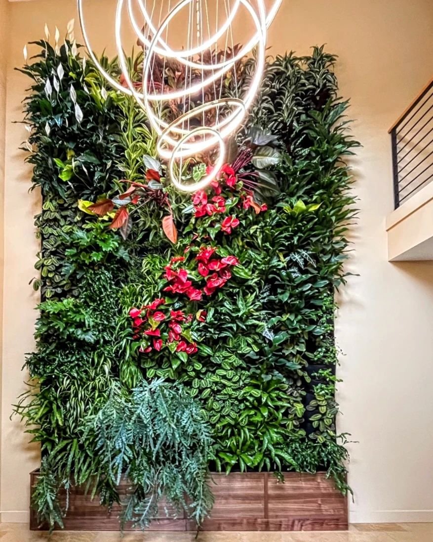 A splash of nature! This dramatically colorful living wall adds elegance to a stunning entryway.  Living wall design by @floraformdesign featuring the @florafelt system. #livingwall #biophilicdesign #indoorplants #plantlover #homedesign