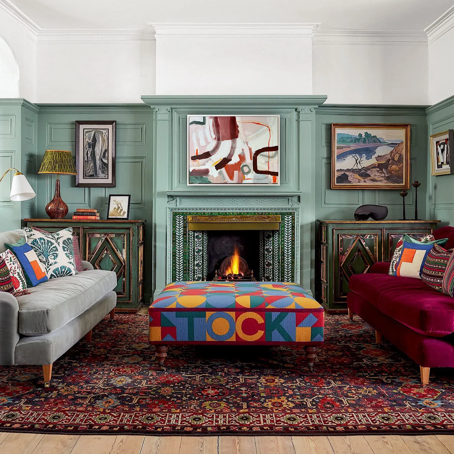 light pink framed abstract painting with brown lines and forms hanging on a cozy fall living room wall