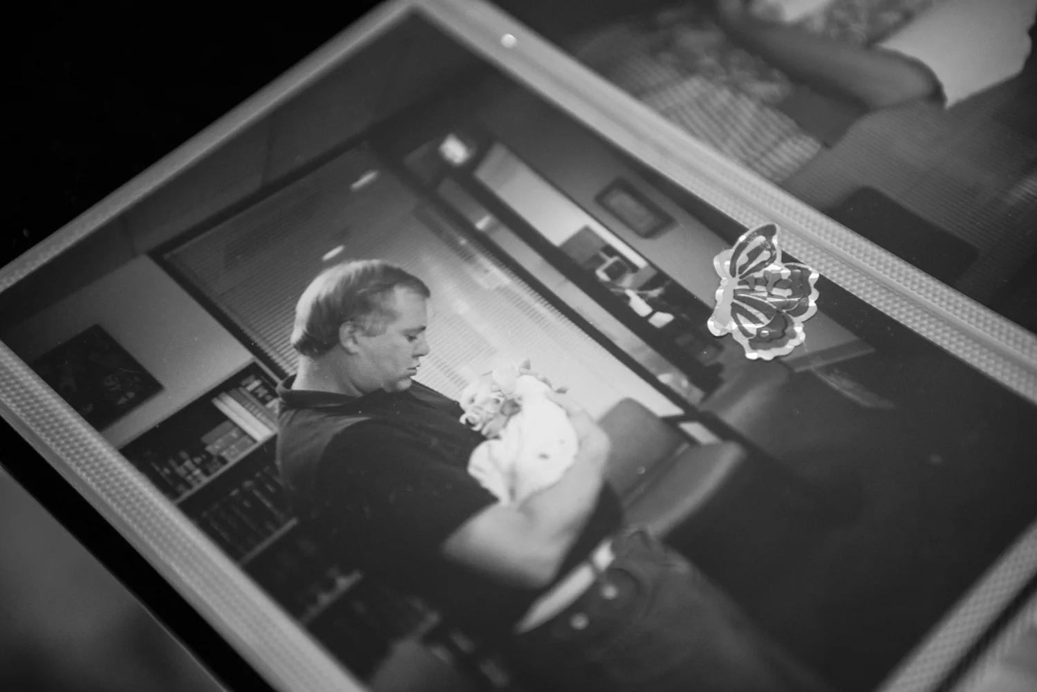  Picture of my adopted father holding me for the first time. The butterfly sticker on the photo was put on me at that meeting by my sister whom I have not met. 