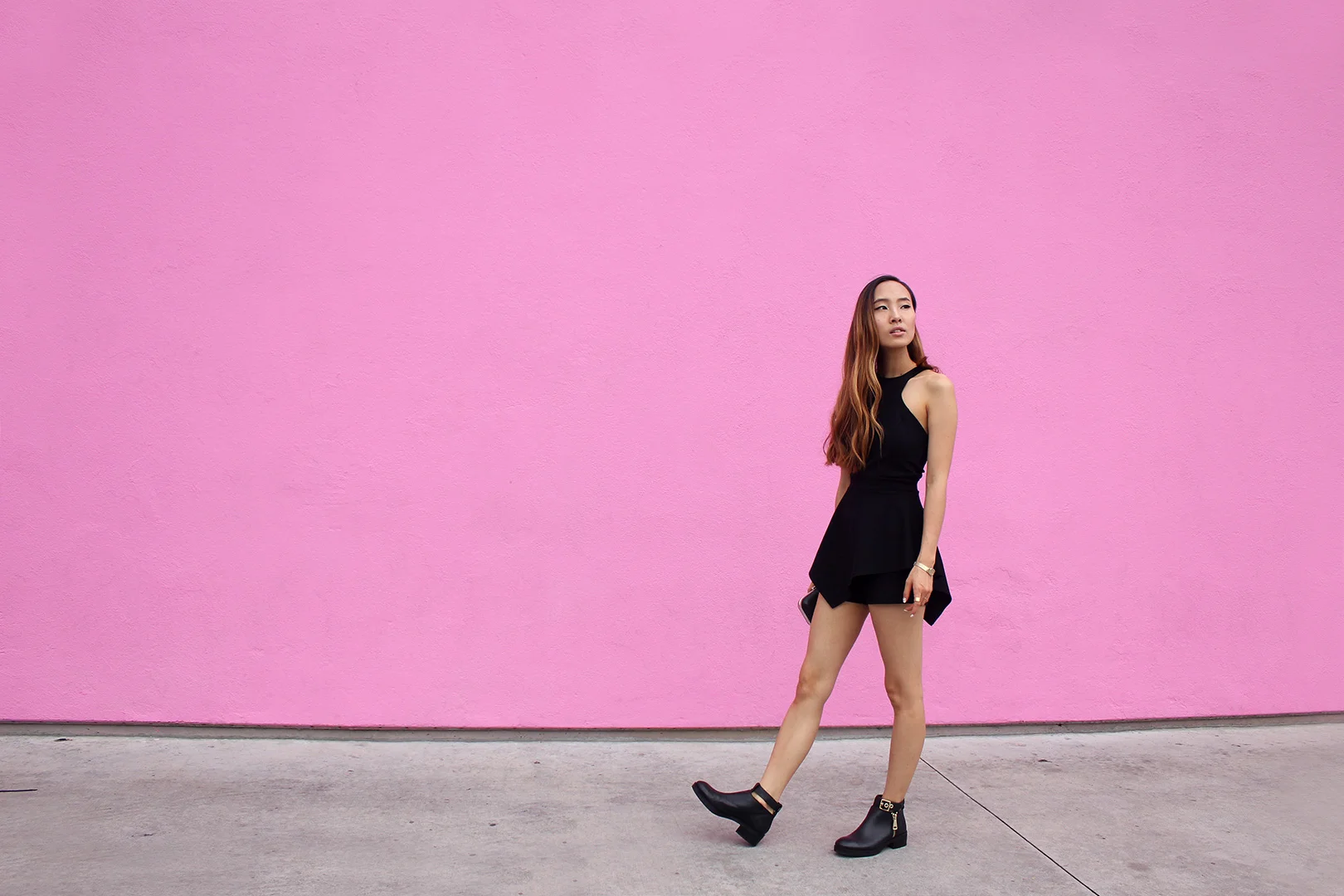 At the pink Paul Smith store wearing a r omper by Nasty Gal and b ooties by Zara.