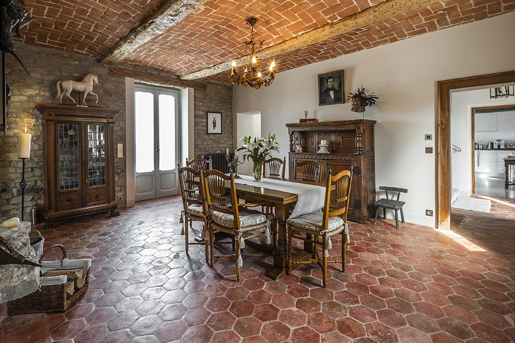 The Main House, originally built in the second half of the XIX Century, has been renewed keeping in mind the original asset and the aesthetics. Entering the house, the ground floor hosts a foyer, a dining room, a kitchen and a living room. While the kitchen is separated from the rest of the chambers by the staircase, the dining room and the living room are perceived as a separated and a unique space at the same time: there are no doors dividing them but, instead, a central double-sided fireplace connects one area to the other.