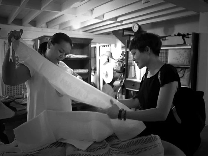 Fabrics are carefully sourced : bamboo, bamboo silk, bamboo fleece, organic cotton and pineapple(pina) silk from the Philippines. ABSTRACTING : Flat shapes drawn from photos of Zimbabwe are cut and draped into clothing. RECONSTRUCT : A Zimbabwean nylon sack for concrete is unravelled, its yarn used as decorative stitching. A linen lace bed sheet becomes a dress.
