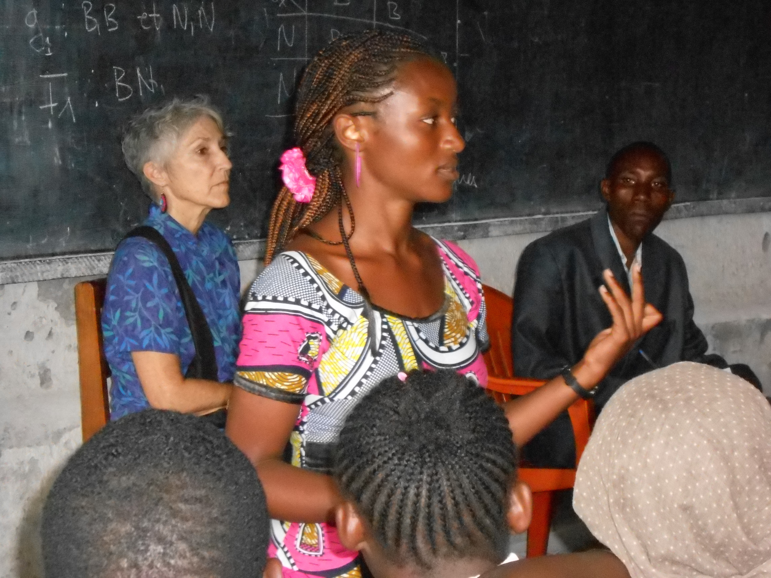 ACT for Congo's Executive Director Judy Anderson watches Peer Educators lead a reproductive health seminar at the local high school in Goma, DR Congo. 