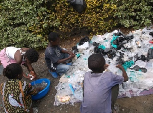 Children collect and sort non-biodegradable garbage from their neighborhood.