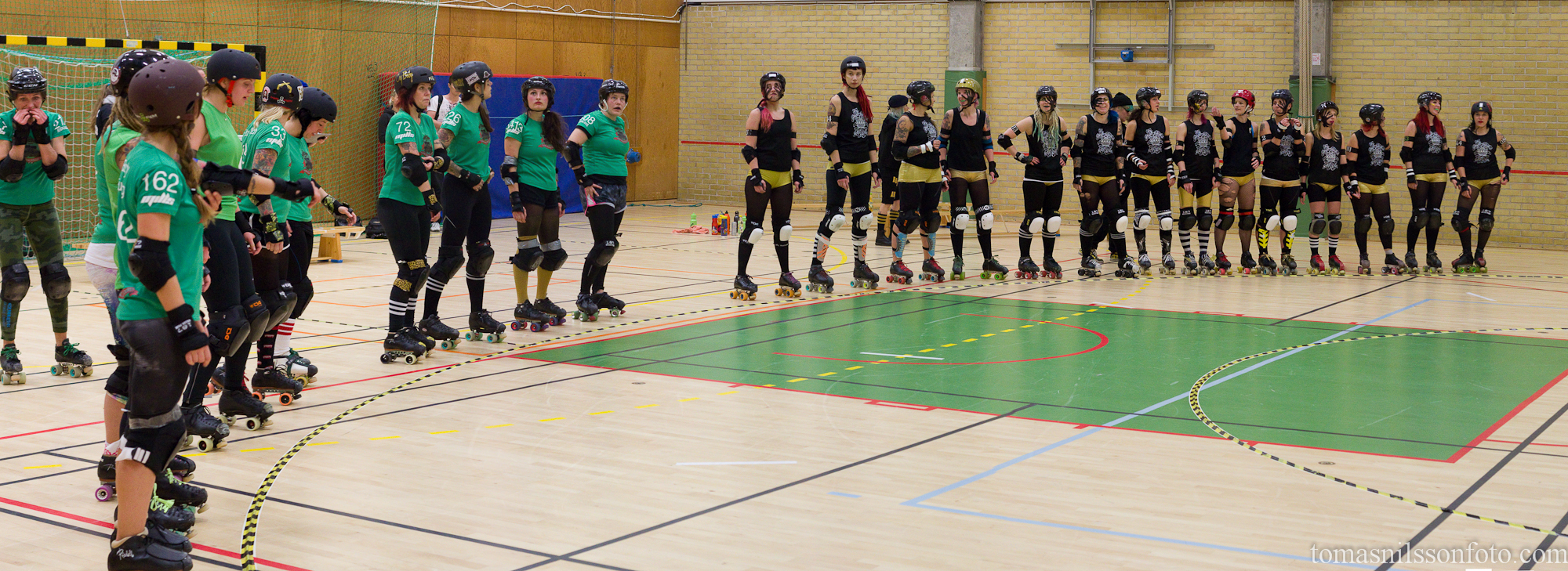The teams line up for the referees' mandatory gear inspection .