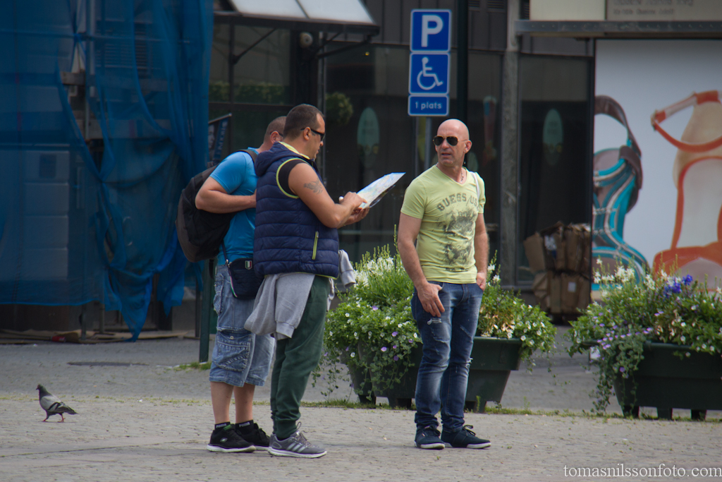 Visitors from Italy trying to find their location on their map.