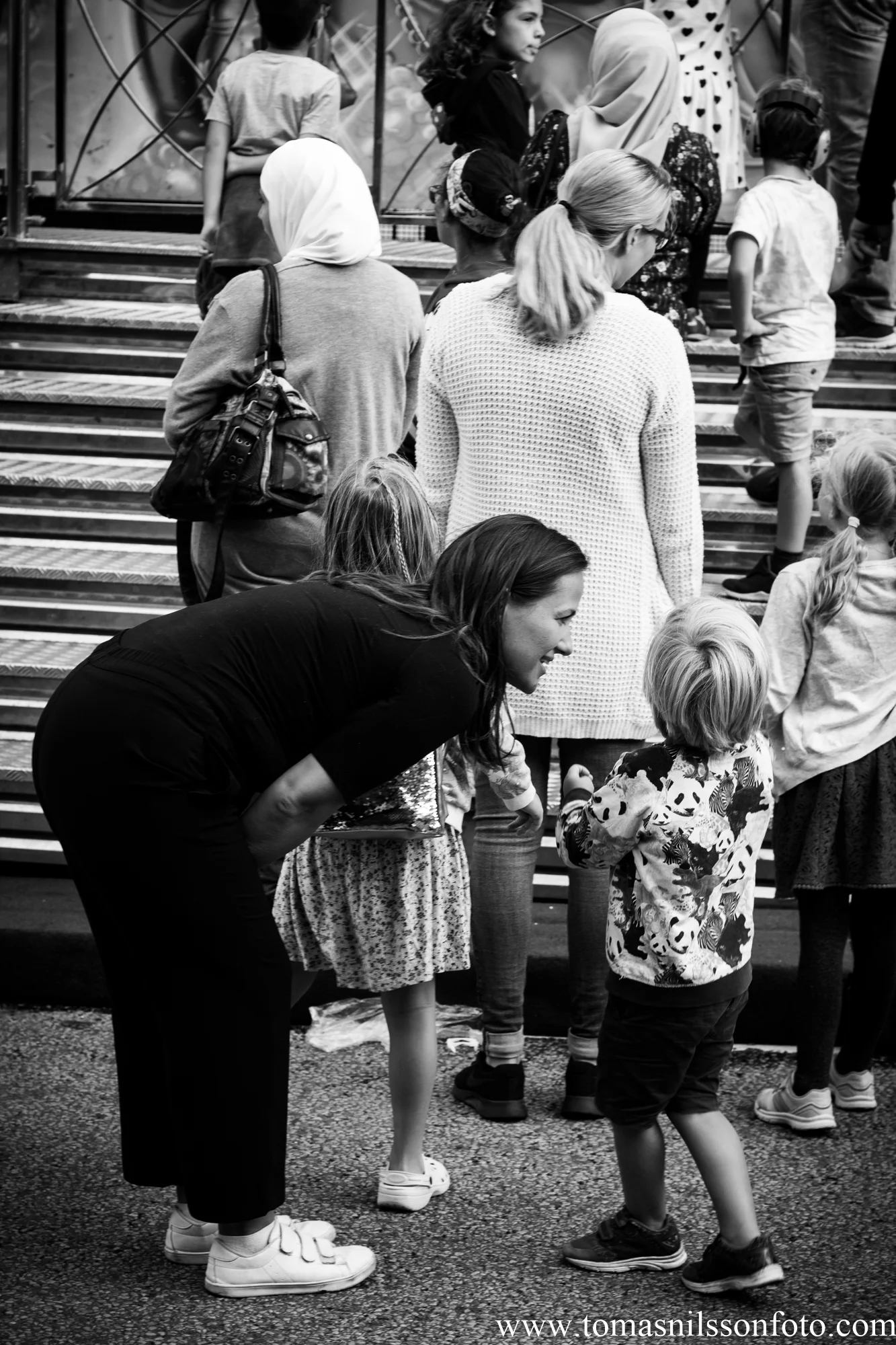 Here I imagine that the mother is telling the kid that “Next year you’ll be big enough for that ride.”