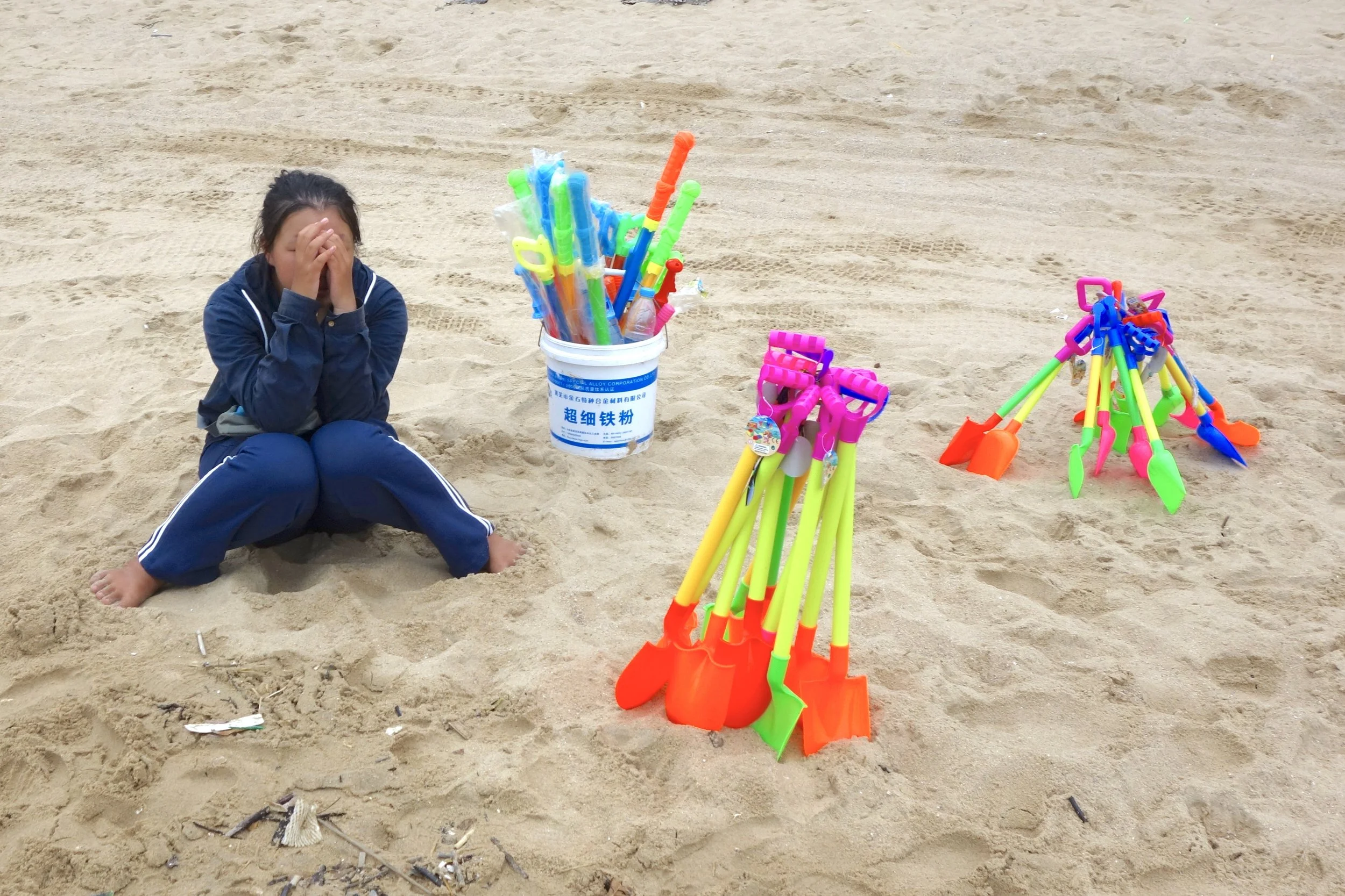 BEACHED GIRL SELLING BEACH TOYS