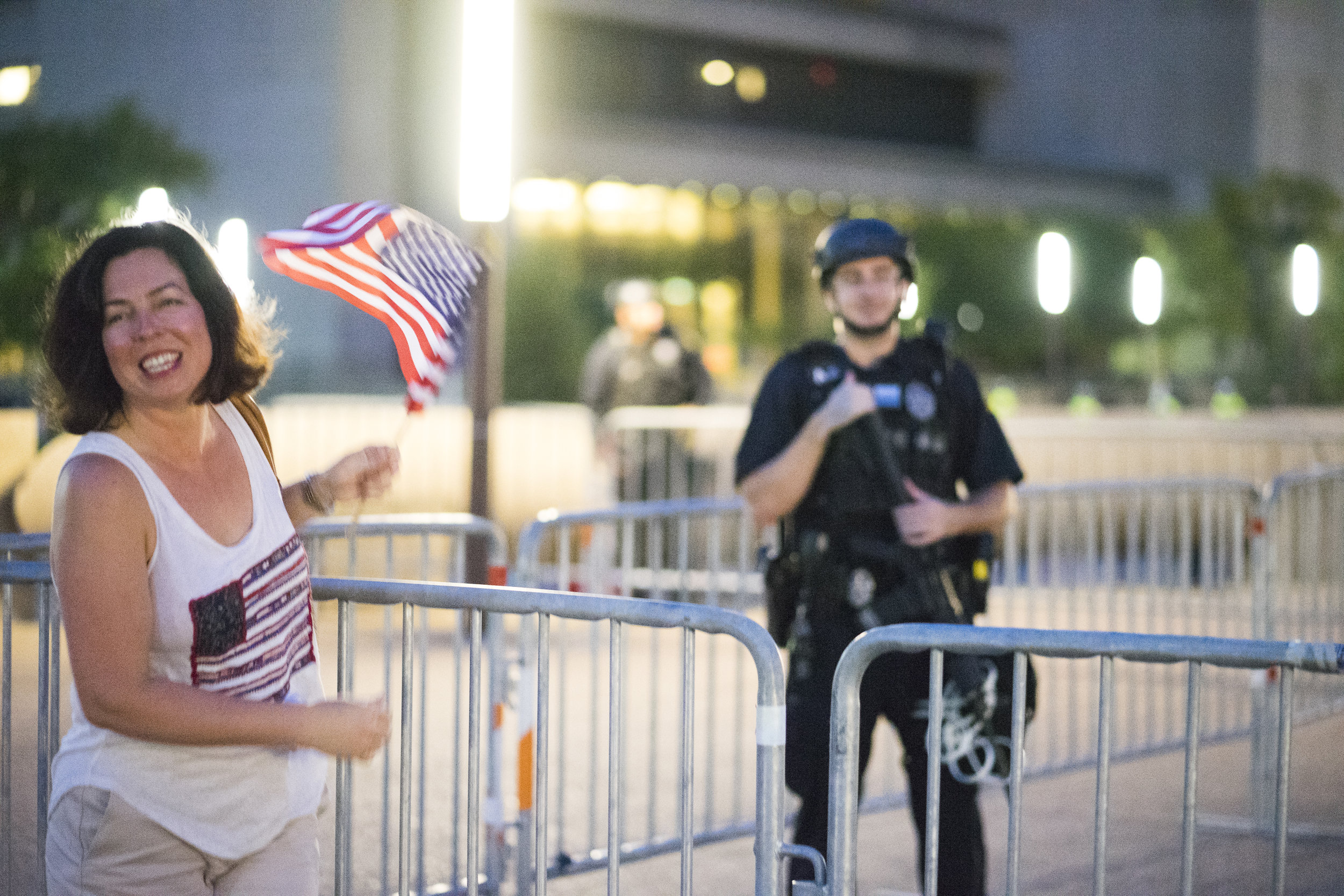 A woman gets her photo taken while posing near Dallas Police officer. August 19, 2017