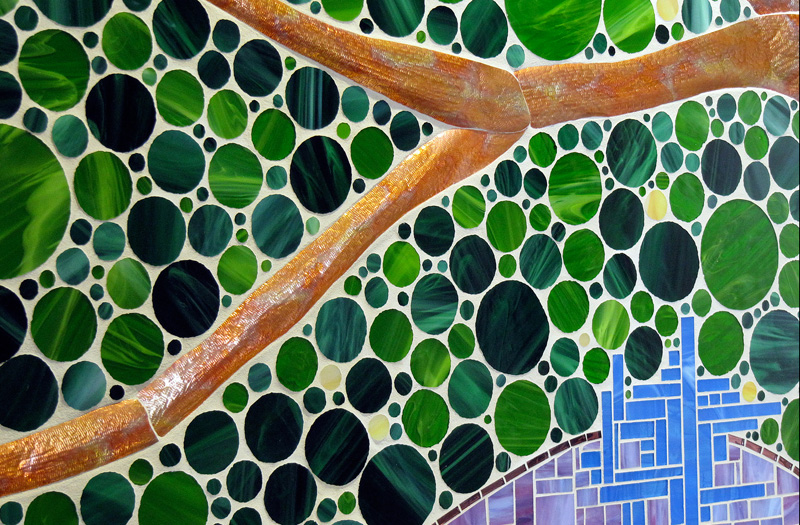 Inspired by Field Paoli, the architects who designed the library, and their green building philosophy, the idea behind this mosaic is bringing a little of the outdoors inside the building. Using hand cut circles to create the tree canopy, the thought was to provide a peaceful nurturing surrounding for the patron coming to quench their thirst. The blue areas of rectangles emulate the sky peaking through the leaves and over the hills of lavender and poppies.