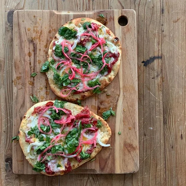 Happy St. Patrick&rsquo;s day. Corned beef naan with Irish cheddar + marinated arugula and spinach for a wee bit o green!