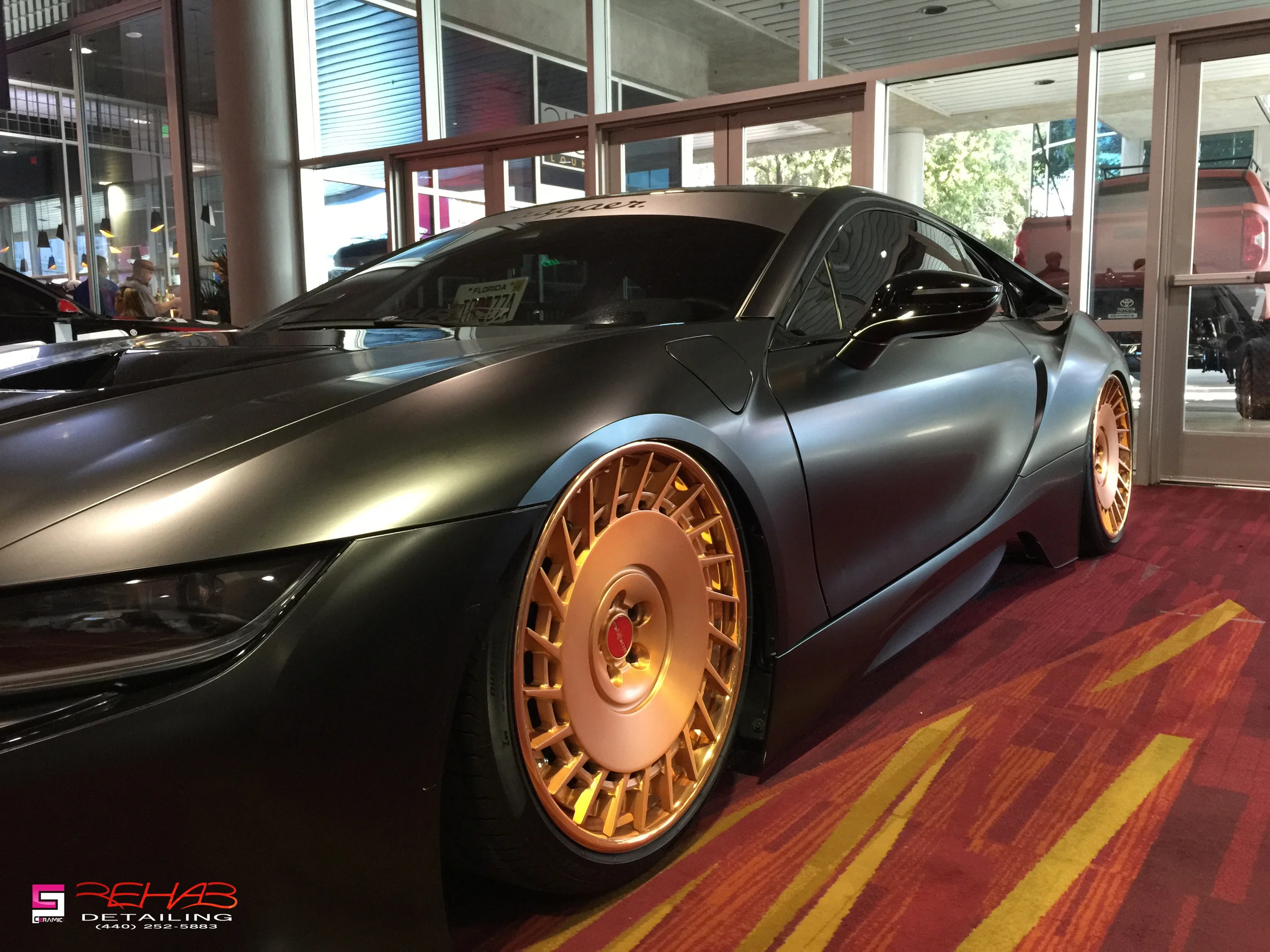 Matte wrapped BMW i8 dumped on air ride and sporting some bronze Rotoform wheels