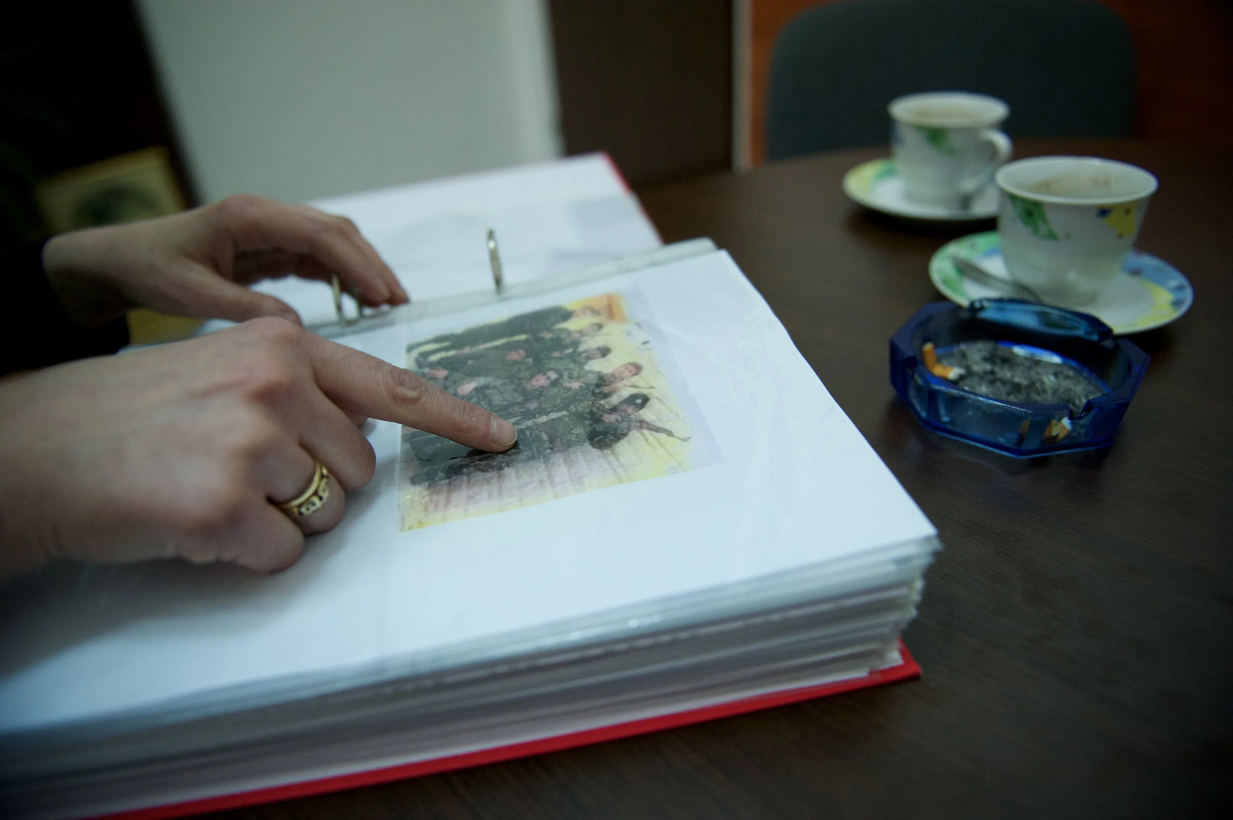 Meliha Merdjić points to an image of the man responsible for the murder and rape of her family. A Bosnian Serb who once lived as her neighbor and drove her school bus.