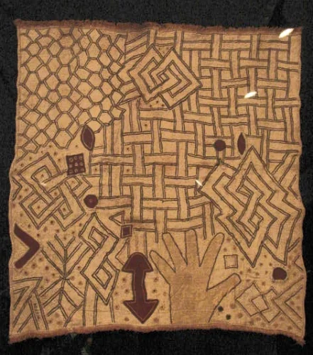Panel (ncák) 20th century; raffia, embroidery, 23-1/4" x 24-3/4 (59 x 63 cm). Musée Royal de L'Afrique Central, Tervuren. It is very rare to see a hand portrayed in a cloth. Perhaps it is a reminder of the atrocious actions of the the Leopold regime? 
