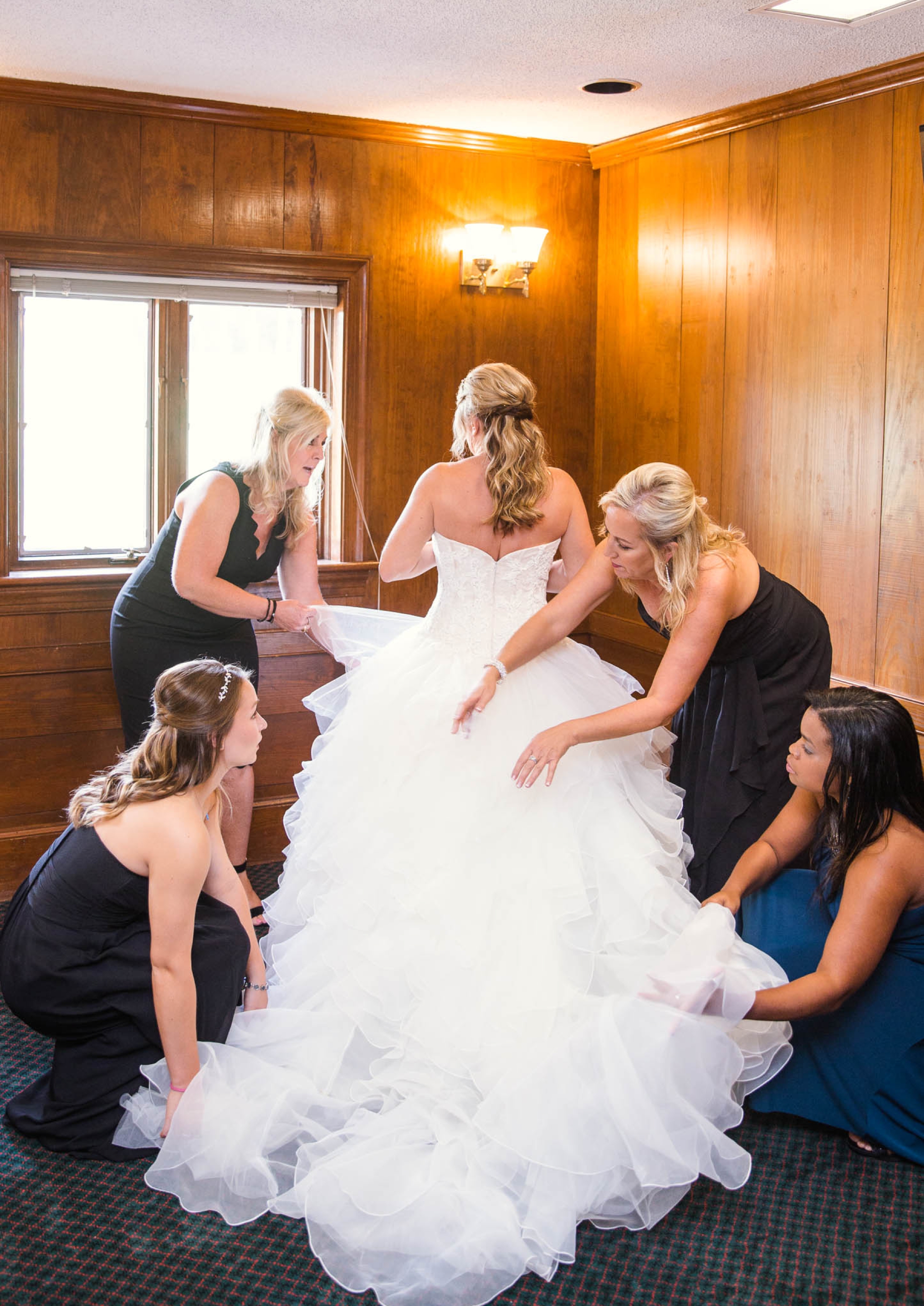 Bridesmaids fluffing the brides ball gown wedding dress - Dona + Doug - MacGregor Downs Country Club in Cary, NC - Raleigh Wedding Photographer