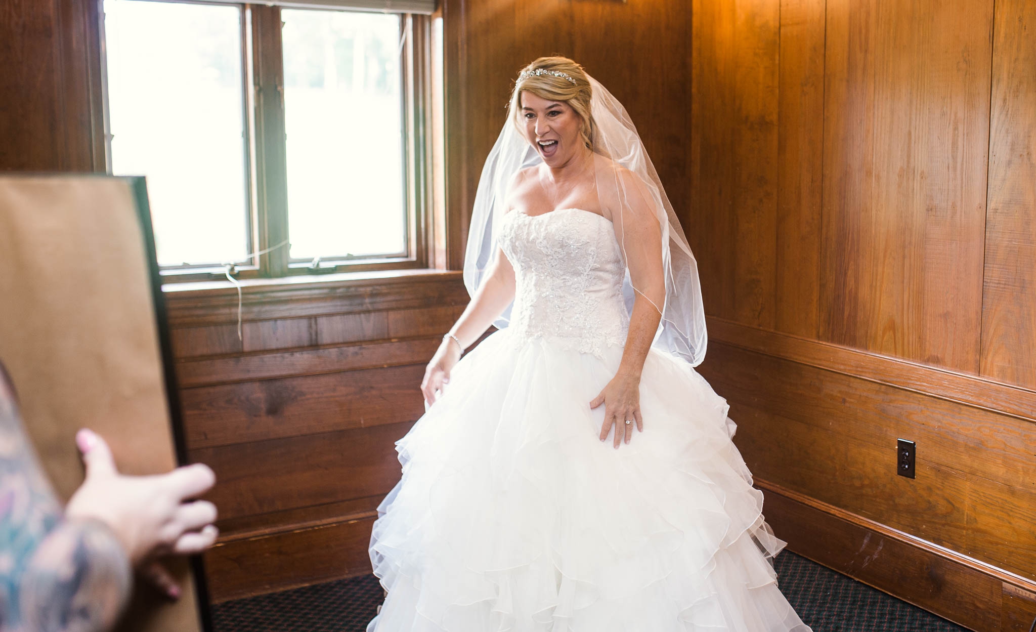 Bride seeing herself in the ball gown wedding dress for the first time - Dona + Doug - MacGregor Downs Country Club in Cary, NC - Raleigh Wedding Photographer